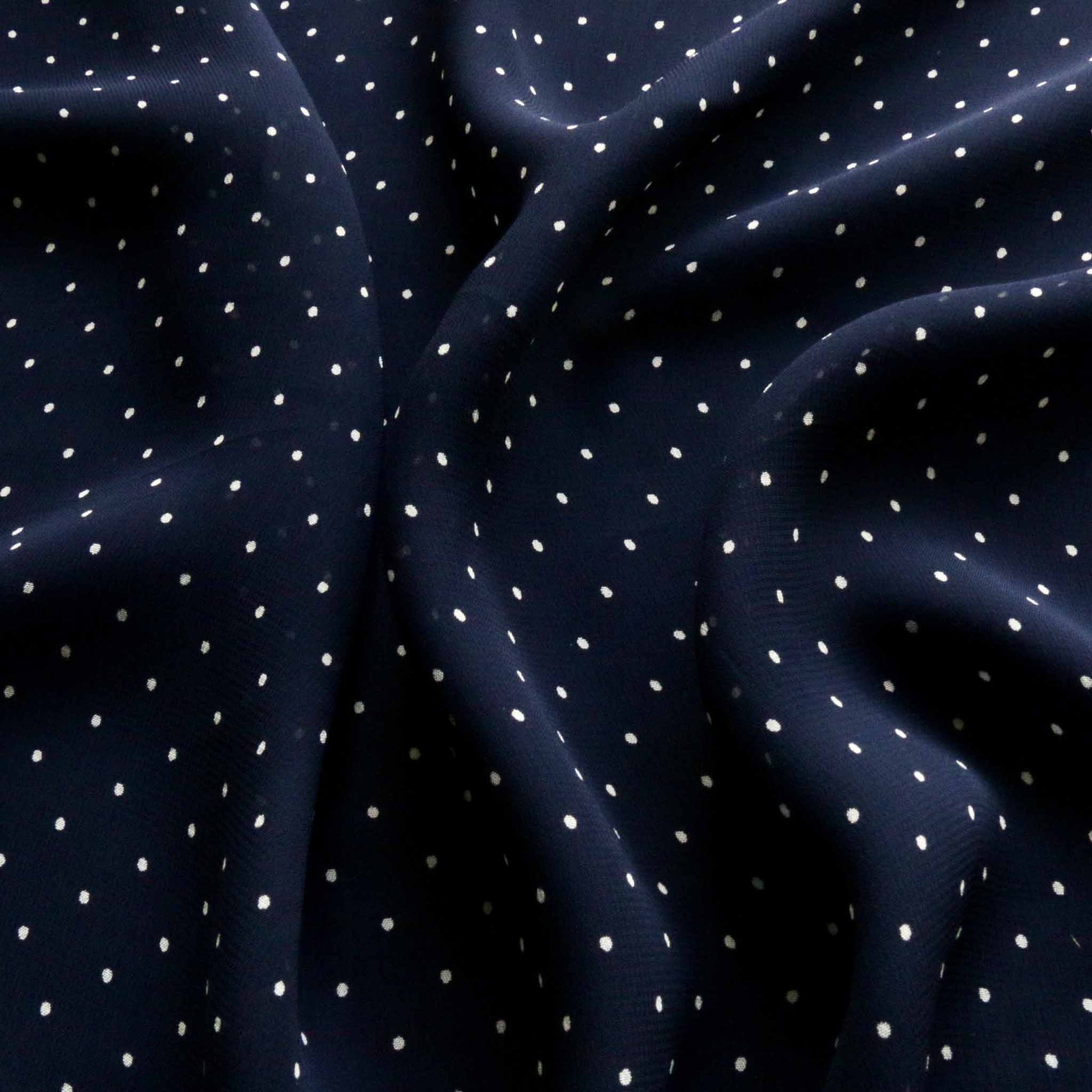 blue viscose chiffon dressmaking fabric with white polka dot design