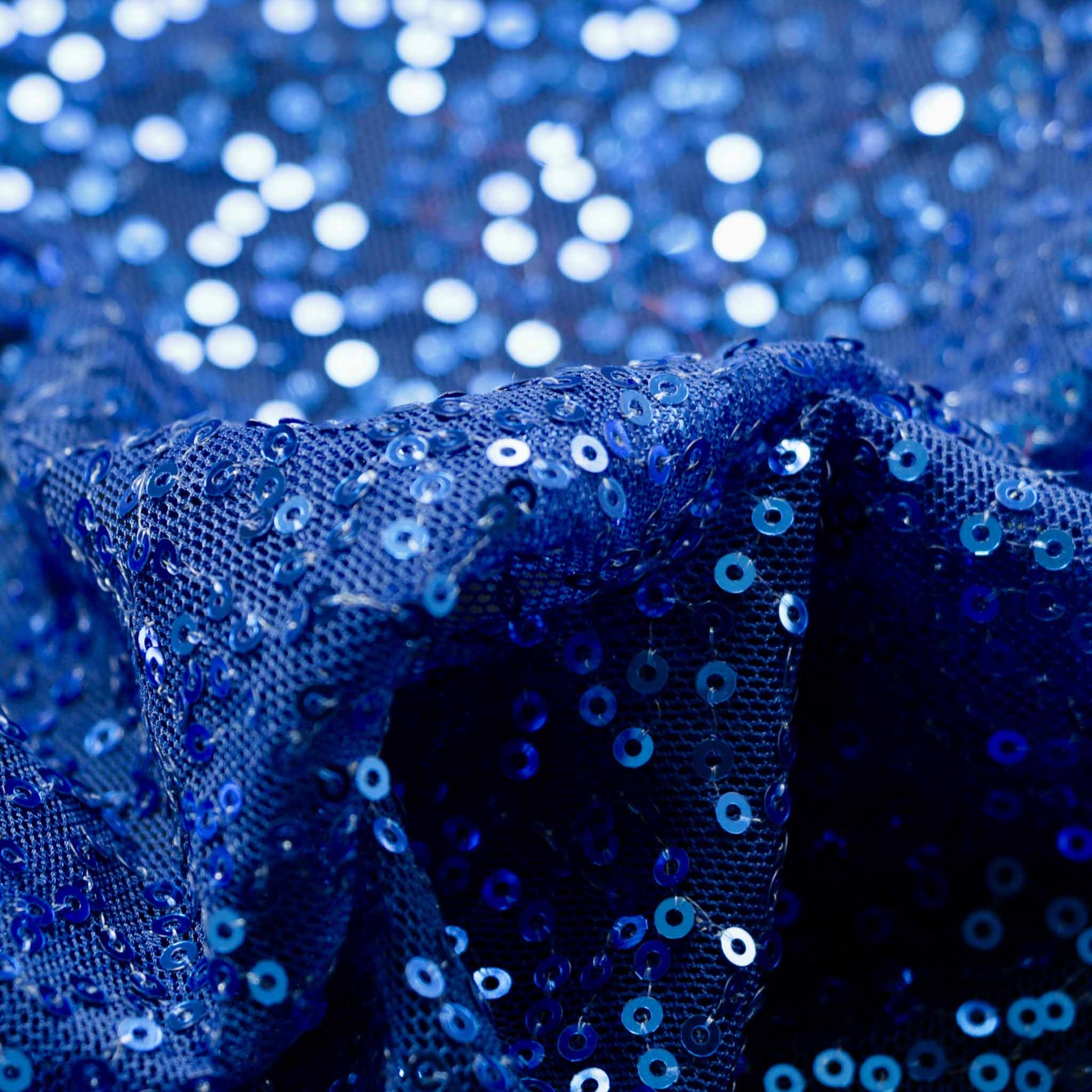 blue sewn sequins on mesh dressmaking fabric