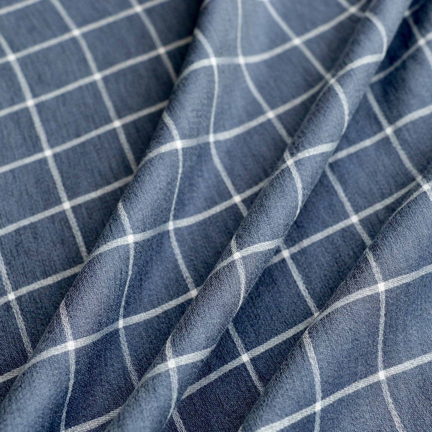 blue and white check pattern on viscose voile dressmaking fabric