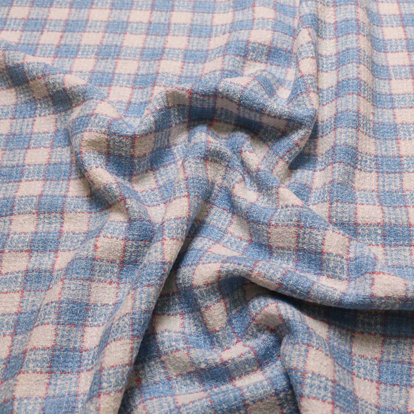 pale blue wool blend boucle dressmaking fabric with check pattern