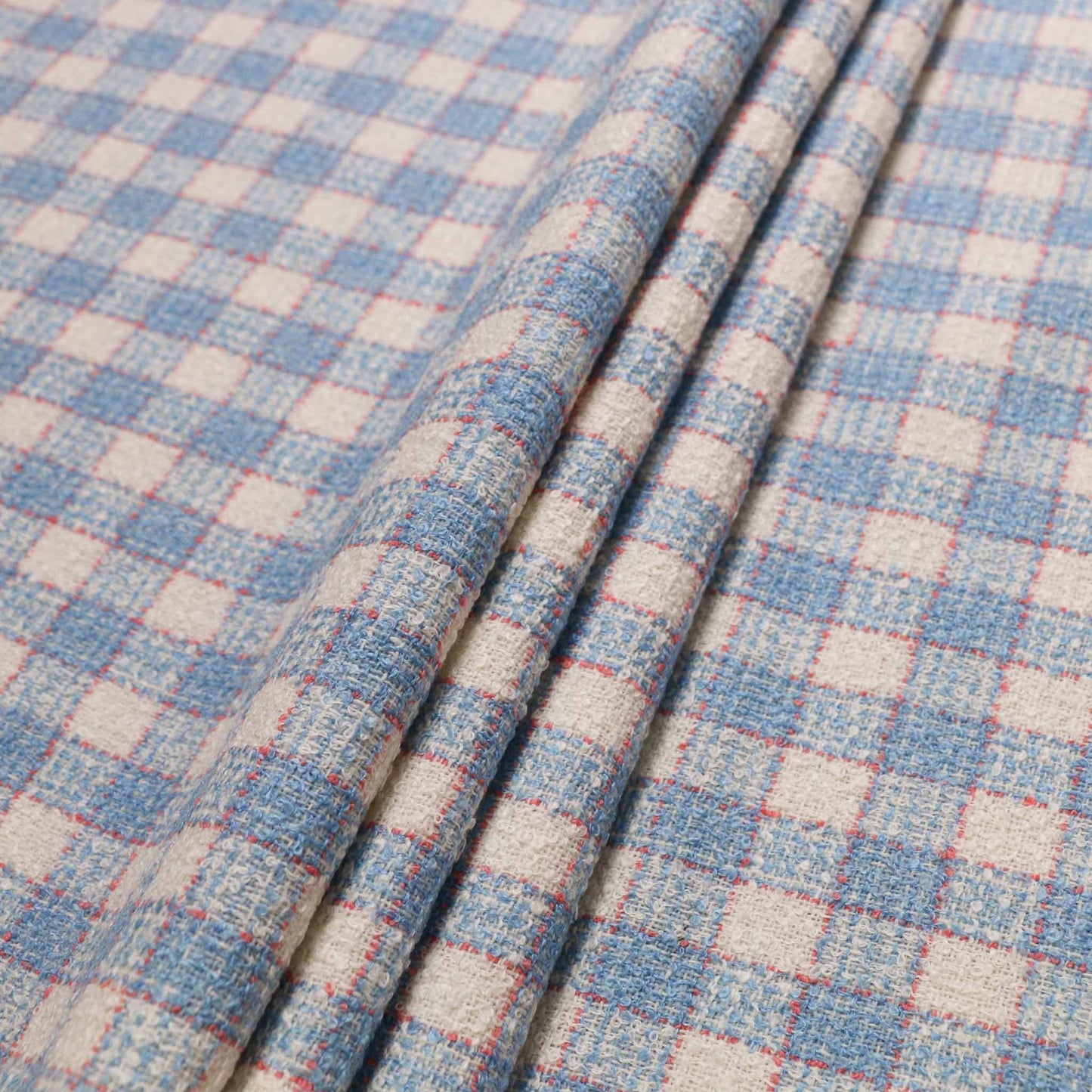 white wool blend boucle dressmaking fabric with pale blue and pink check pattern