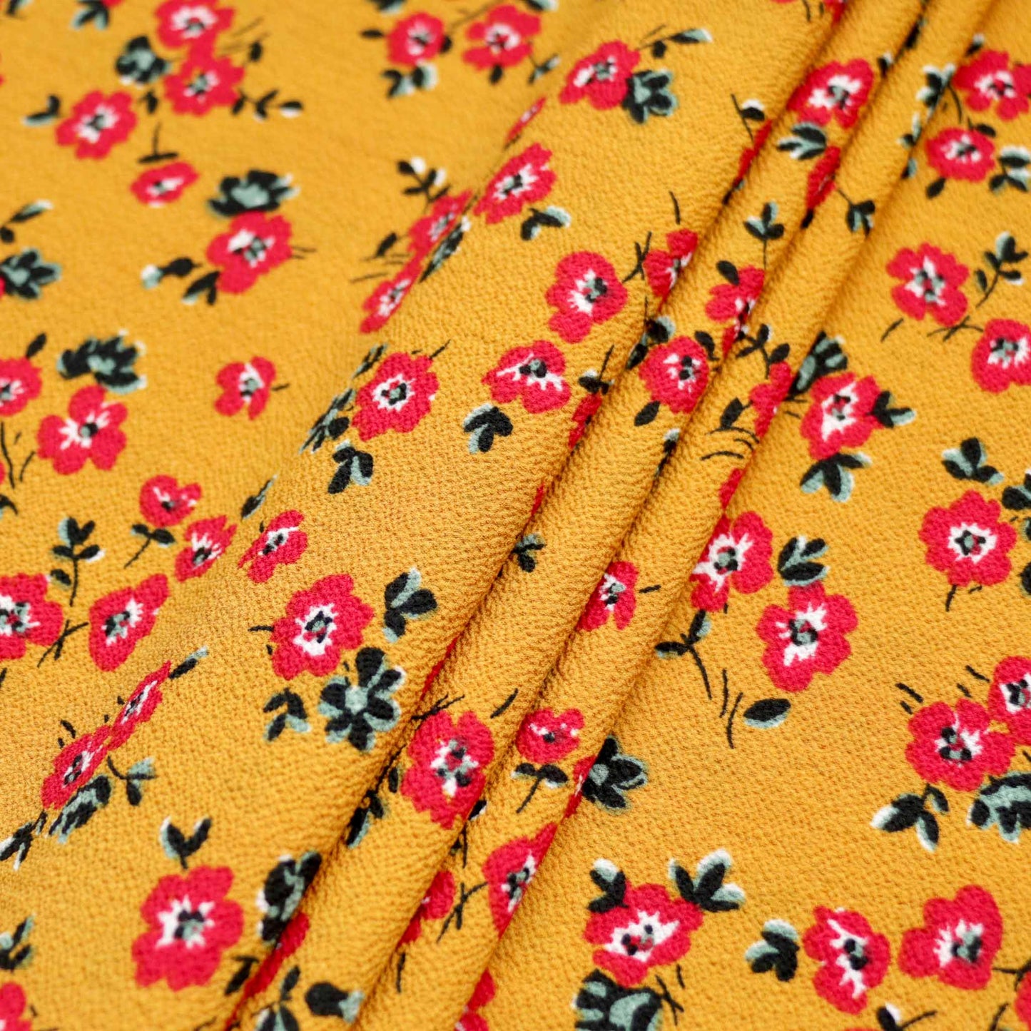 bubble crepe dressmaking fabric in mustard with red printed flower design