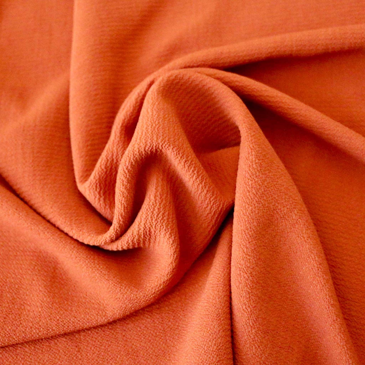 orange bubble crepe plain dressmaking fabric