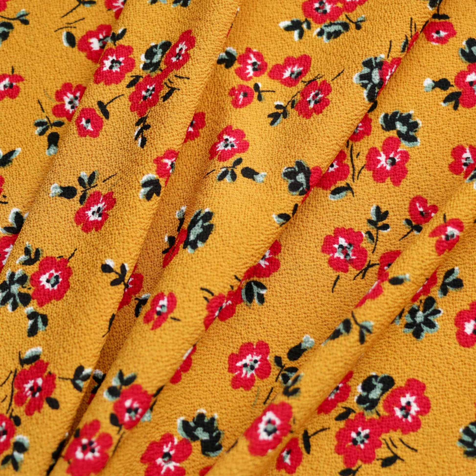 mustard colour bubble crepe dressmaking fabric with floral print in red