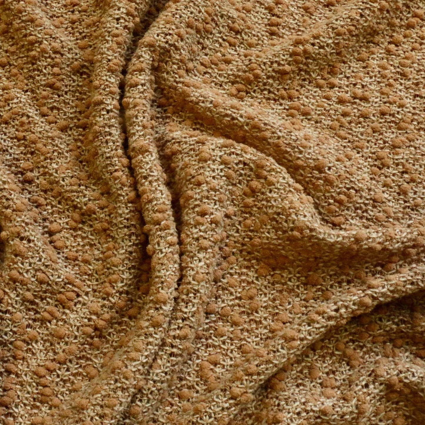 boucle dressmaking fabric in brown with scrunch stretch design
