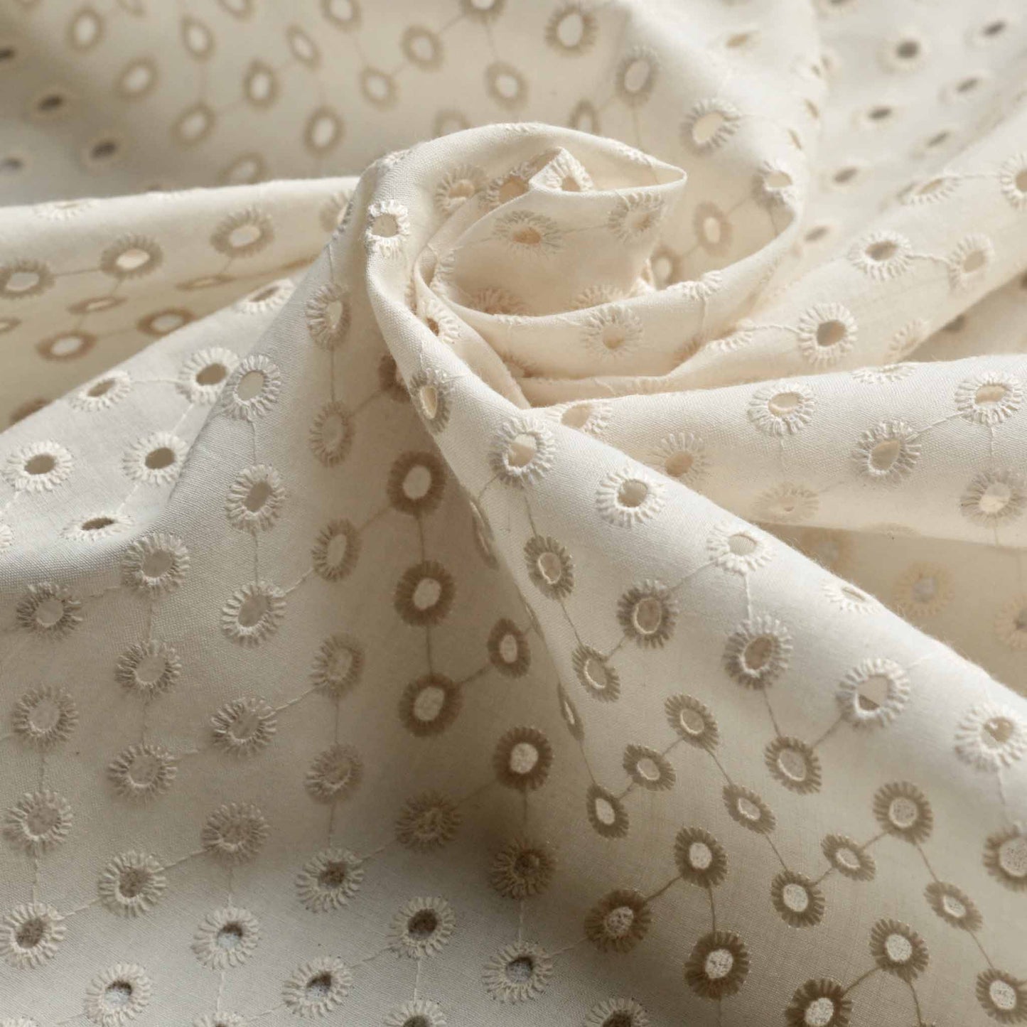 ivory coloured broad anglaise dressmaking fabric with one hole embroidery pattern