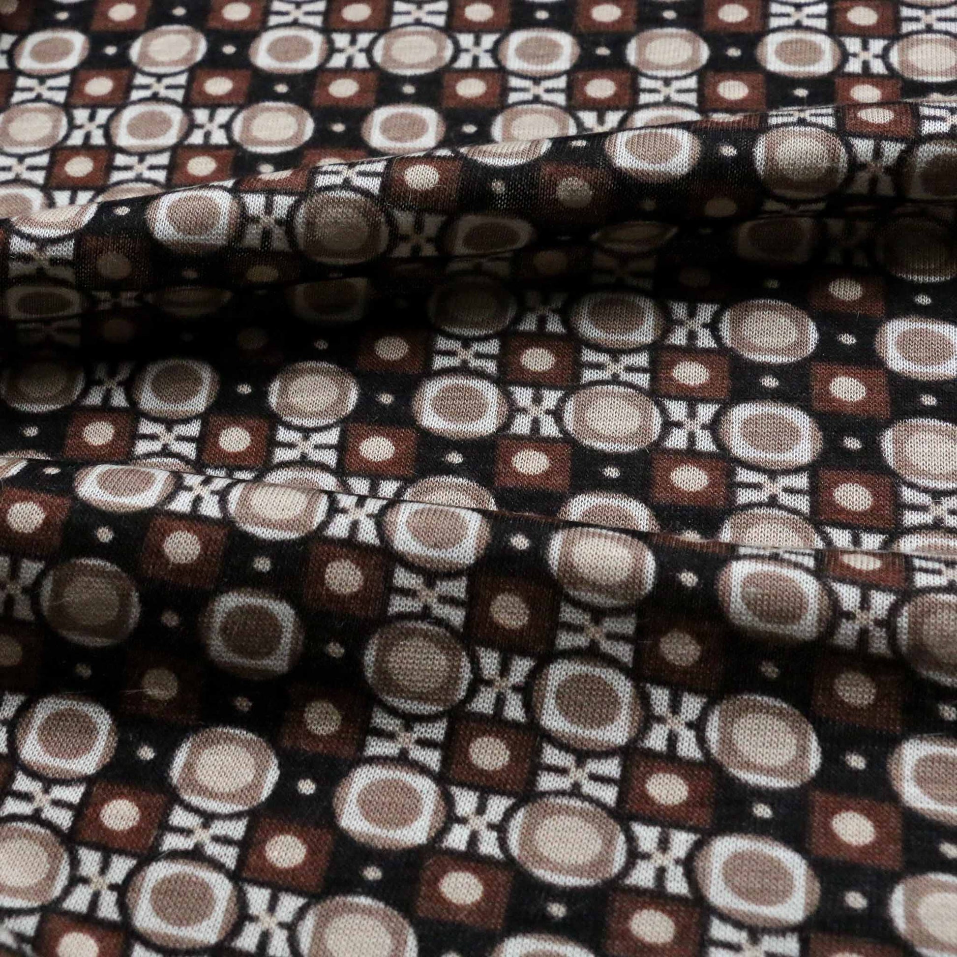 brown and black vintage sustainable deadstock jersey dressmaking fabric with retro print design
