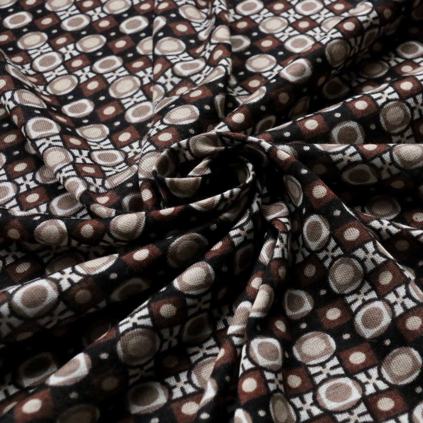 sustainable deadstock retro printed jersey knit vintage dressmaking fabric with black and brown printed pattern