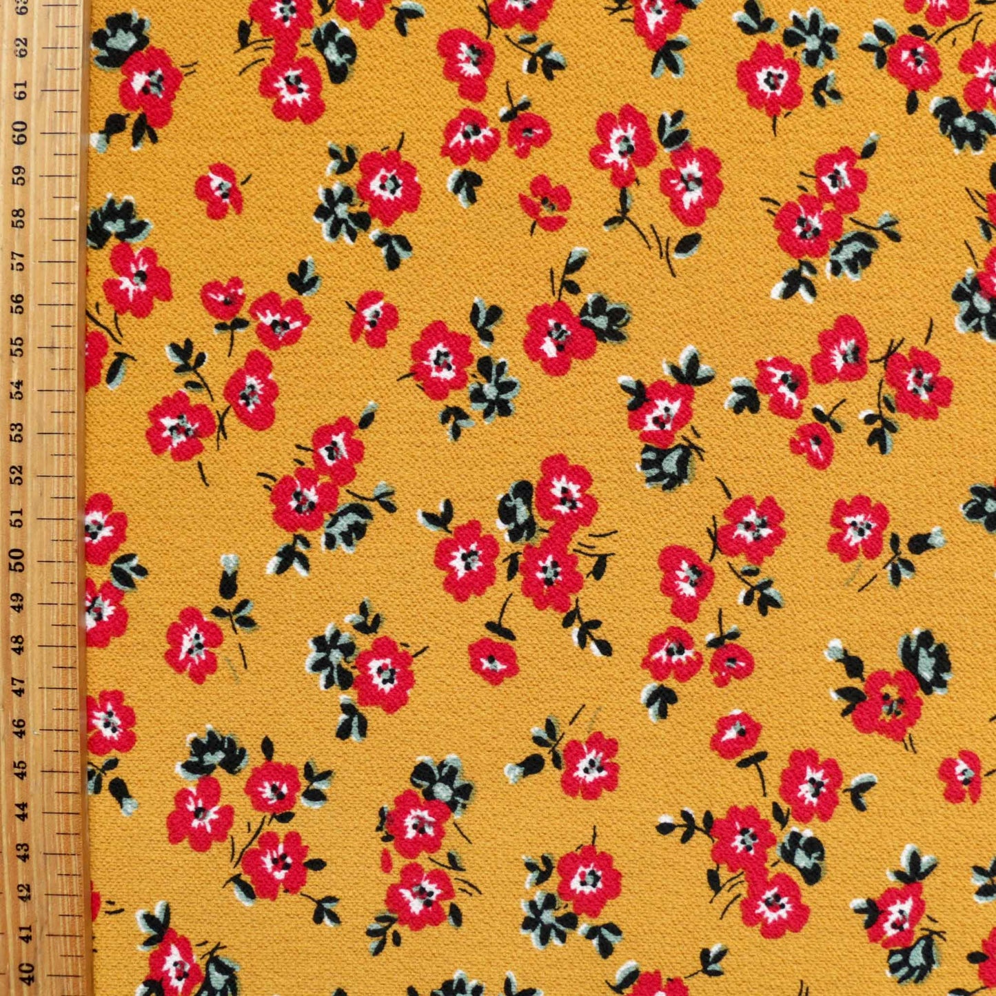 metre beige bubble crepe dressmaking fabric with printed red floral flowers