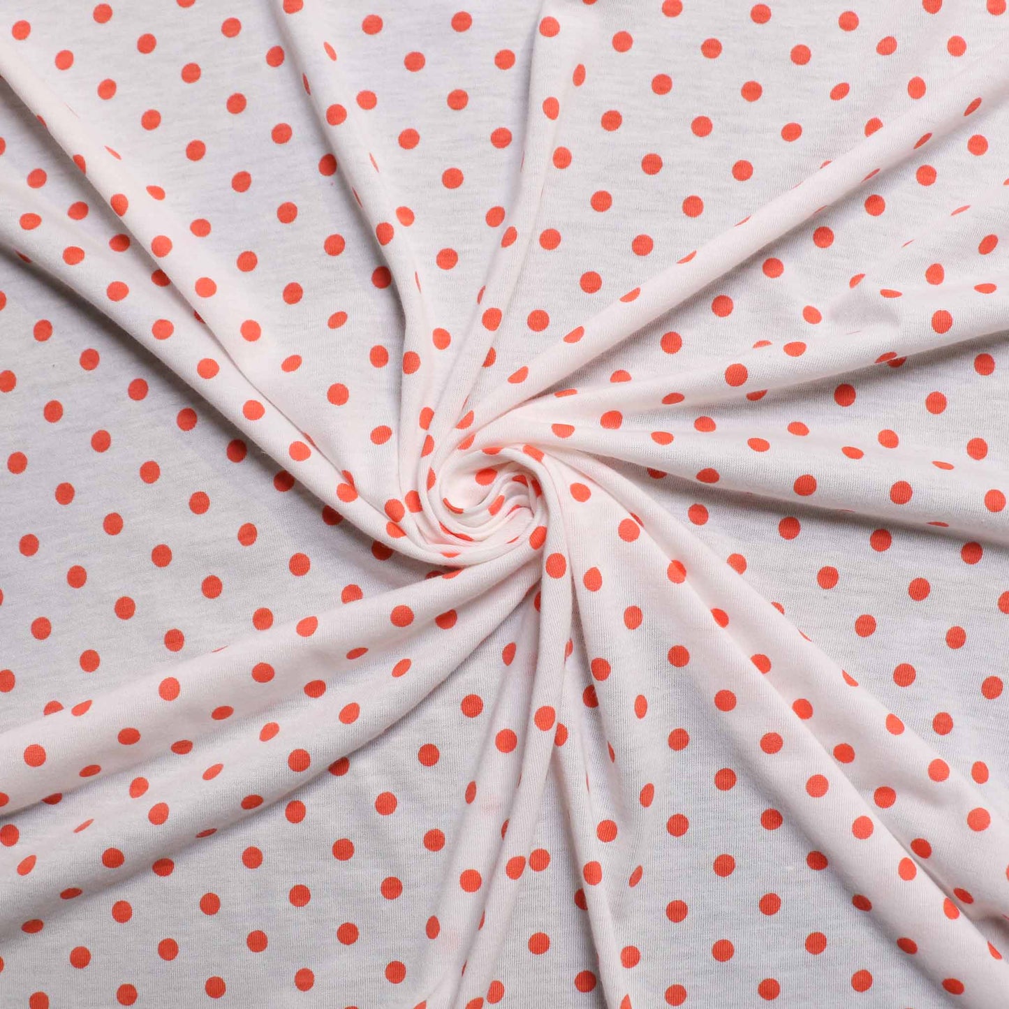 white and orange polkadot coral jersey dressmaking fabric