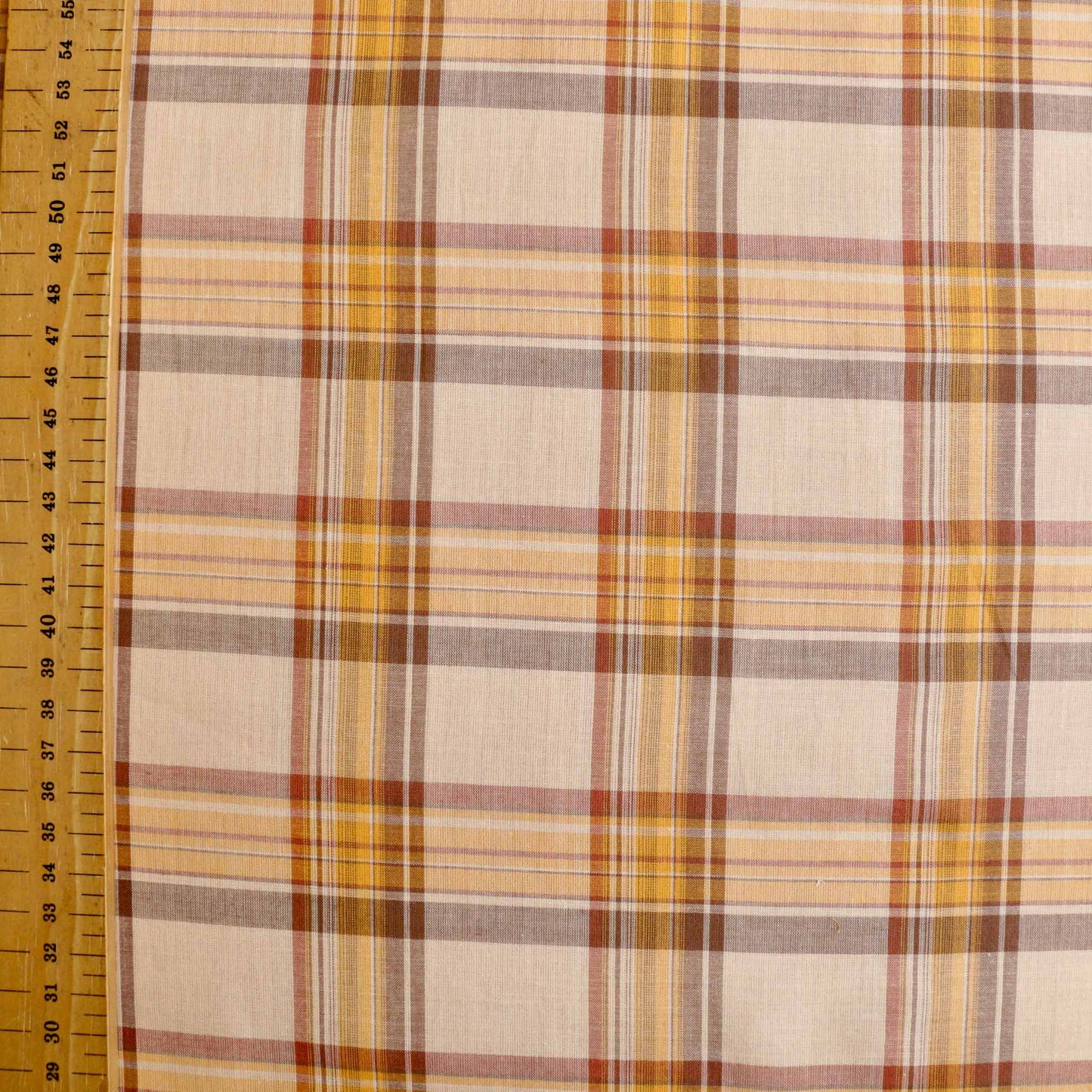 metre cotton dressmaking fabric in pale beige with brown check pattern