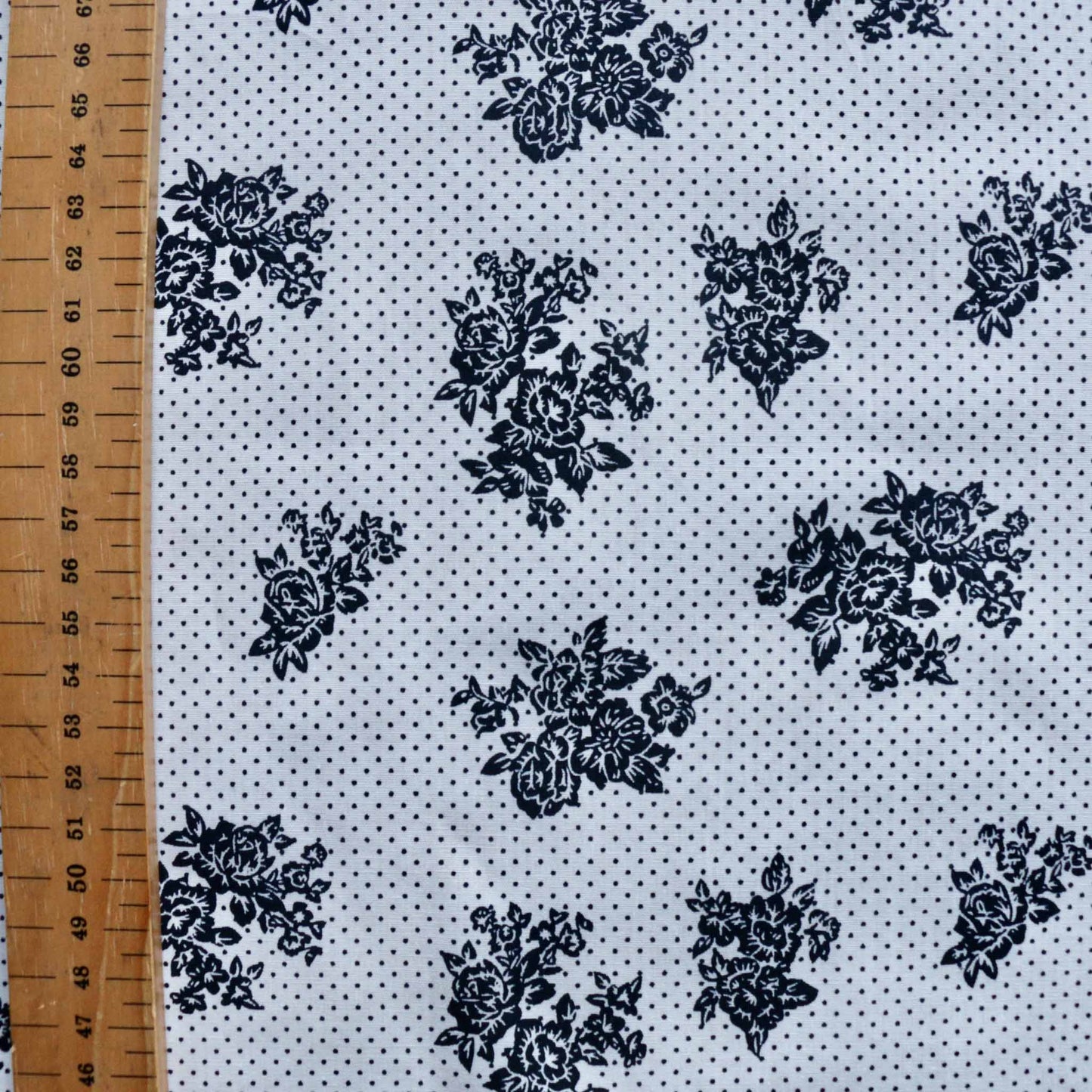 metre cotton poplin dressmaking fabric with navy flower and polka dot print