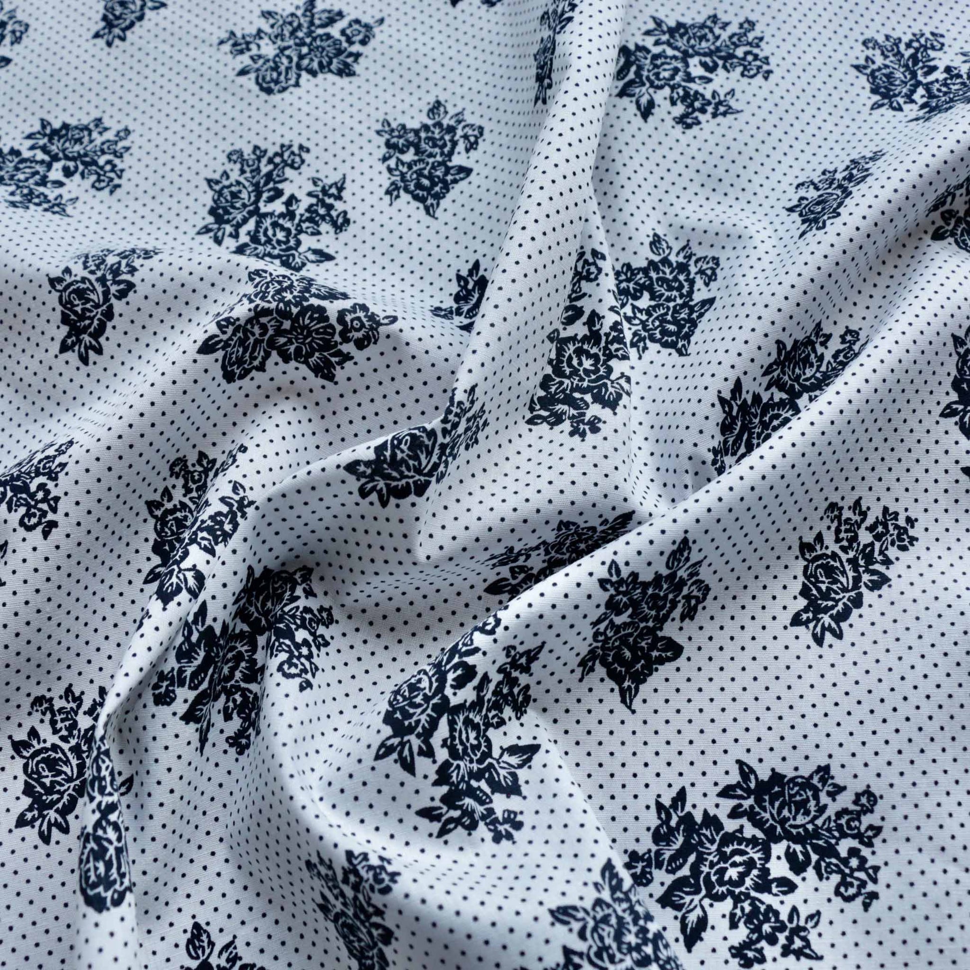 white cotton dressmaking fabric with navy dots and floral pattern