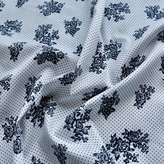 white cotton dressmaking fabric with navy dots and floral pattern
