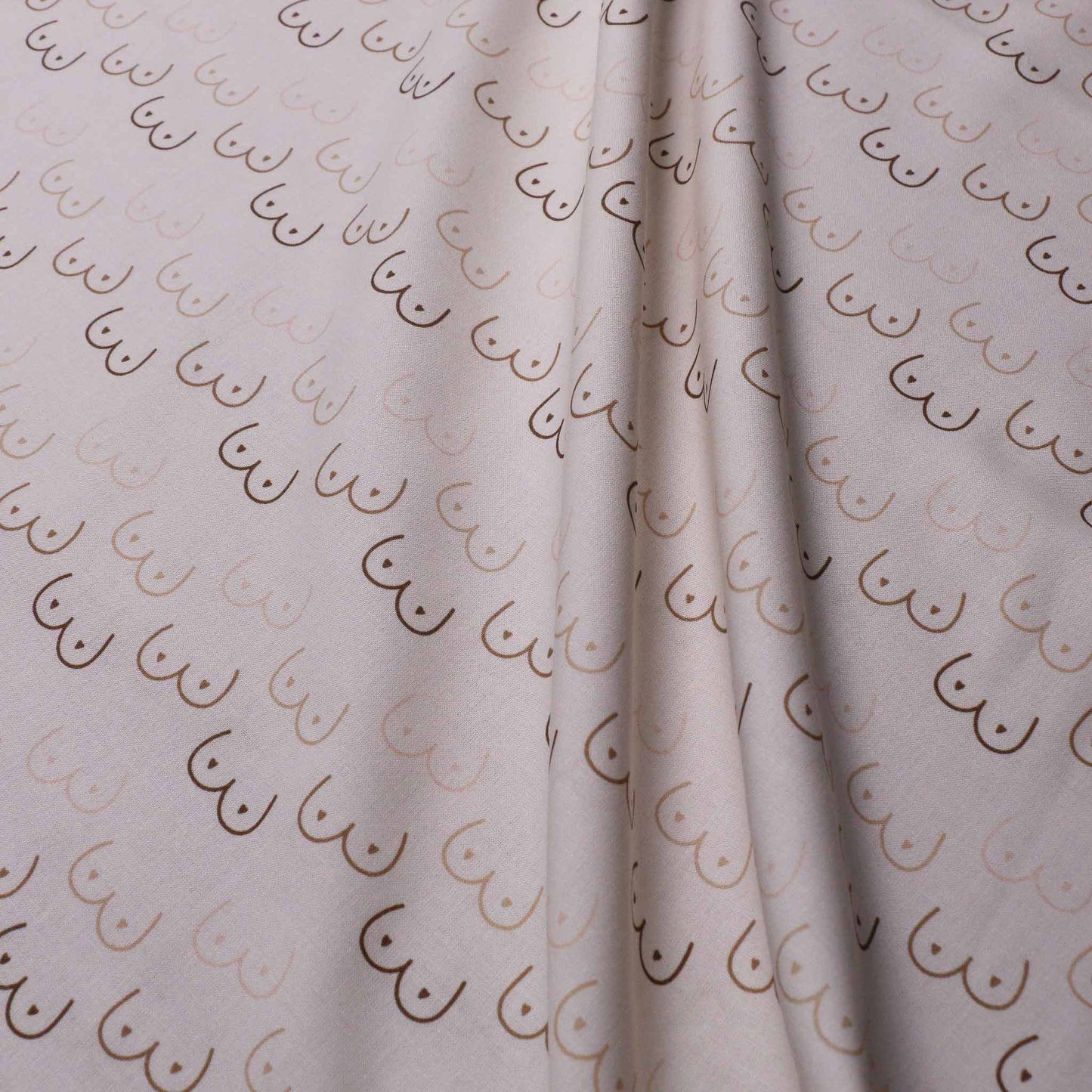 cream cotton dressmaking poplin fabric with cheeky boobie print