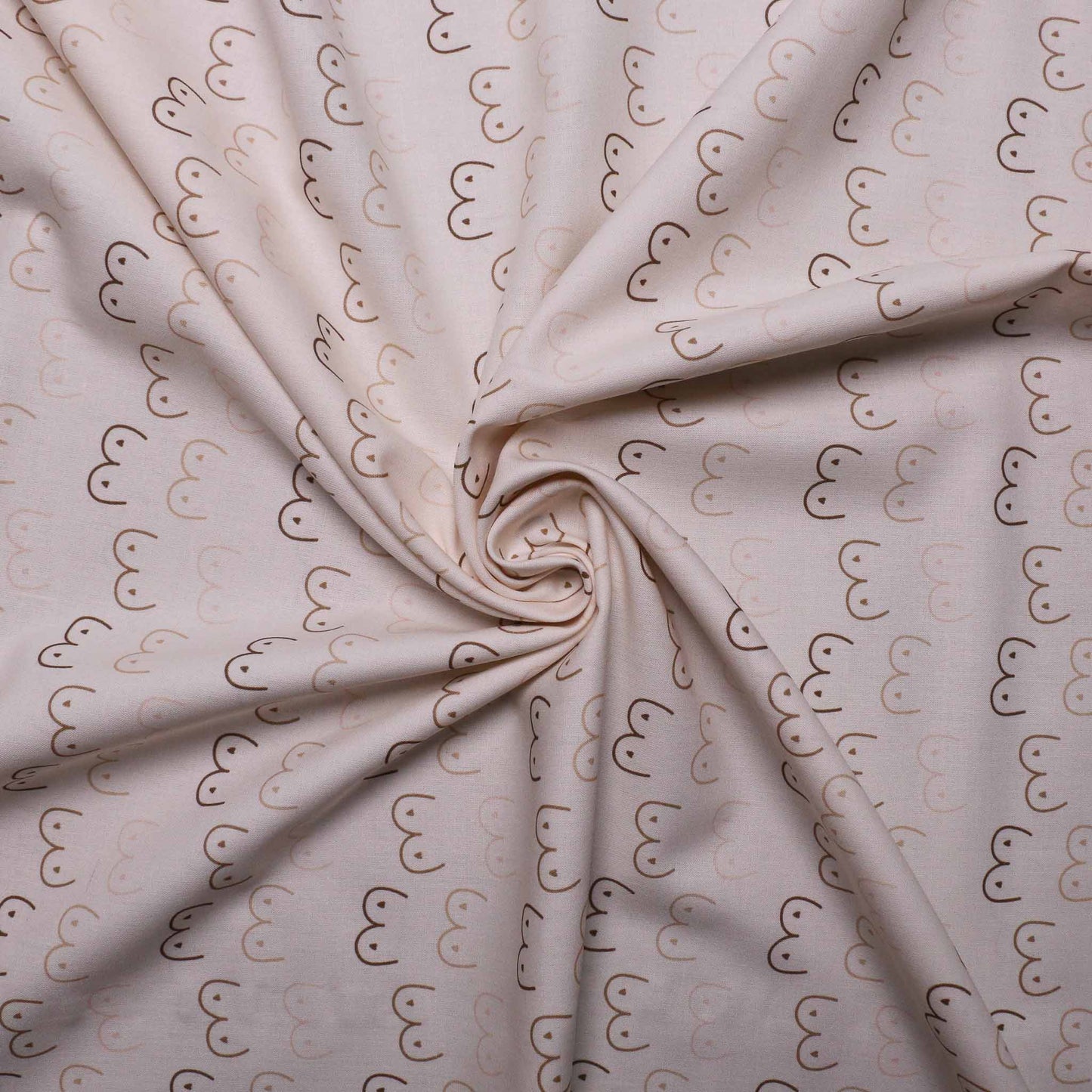 folded cream pure cotton dressmaking fabric with beige boobie print