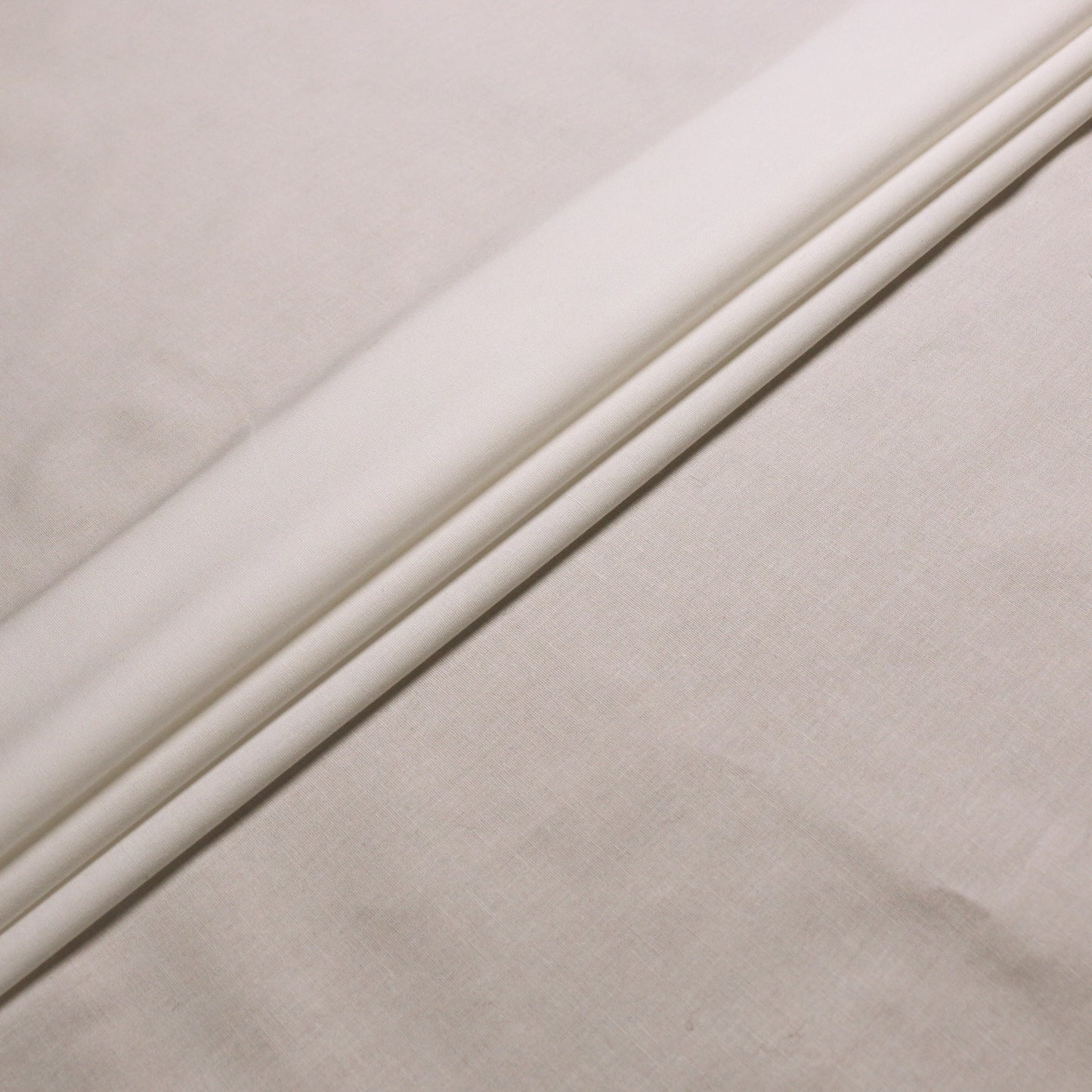 plain cream stretchy cotton dressmaking fabric