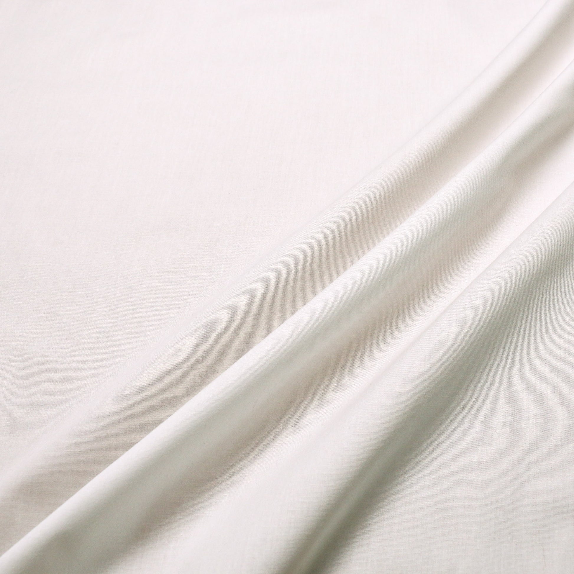 cream plain dressmaking fabric with stretch