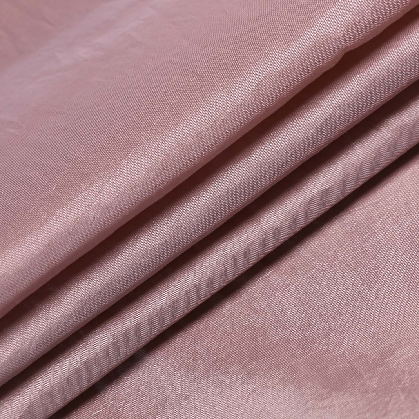 folded dusty pink taffeta dressmaking fabric