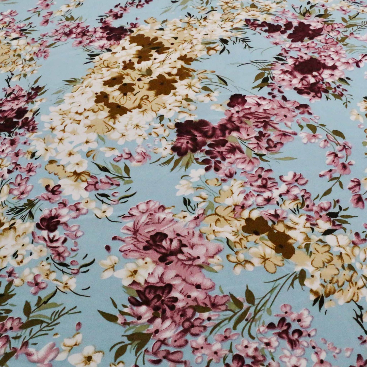 pale blue chiffon polyester synthetic dressmaking fabric with beige and maroon printed flowers