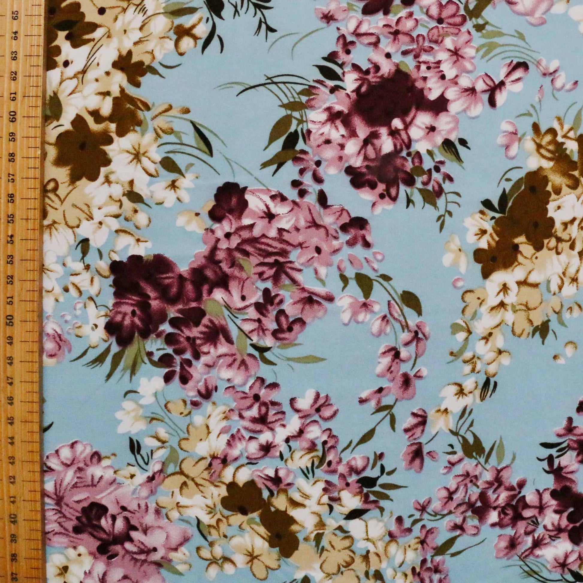 metre chiffon polyester dressmaking fabric in pastel blue with floral print in maroon and beige