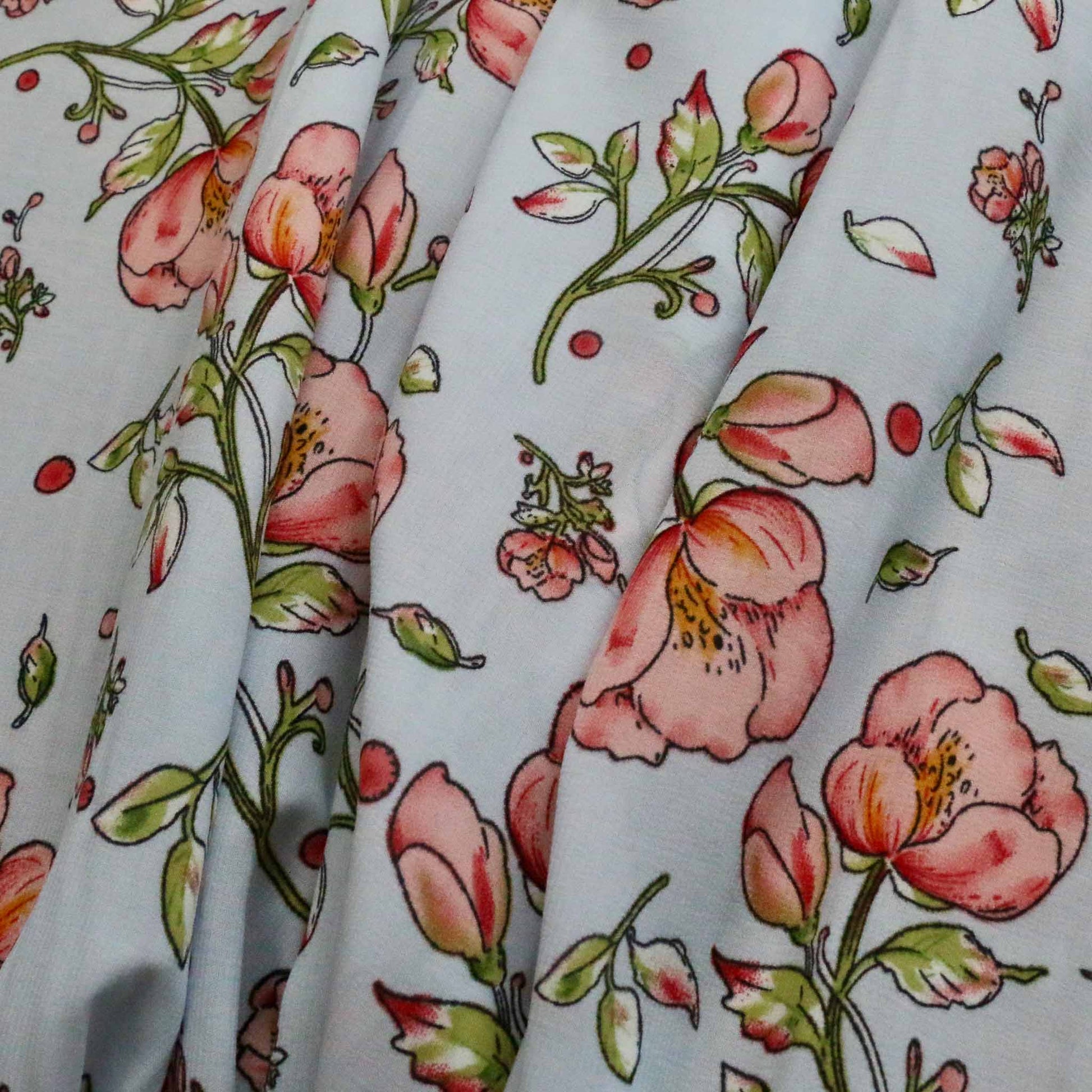 pink flowers printed on pale blue stretchy chiffon polyester synthetic dressmaking fabric