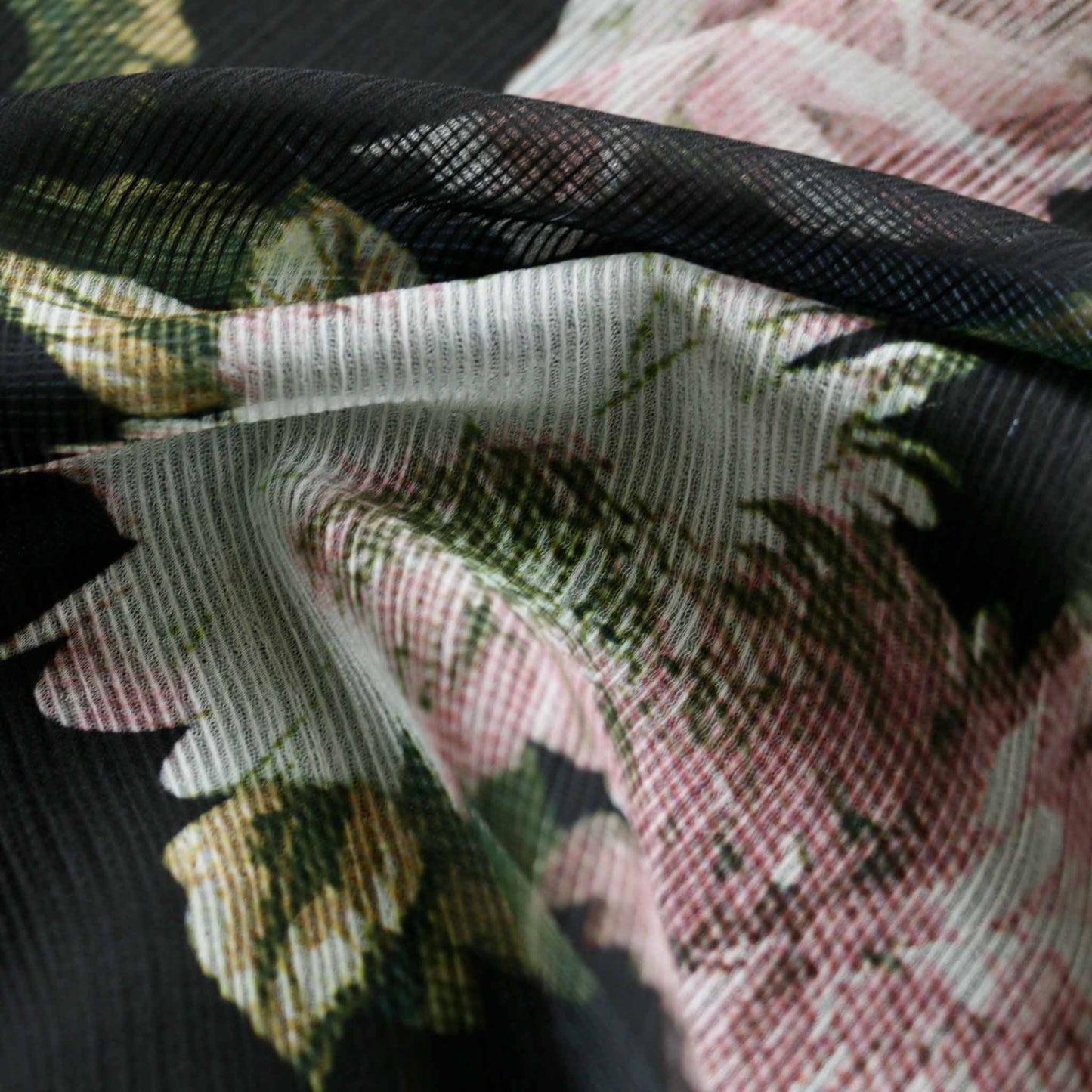 black stretchy chiffon polyester dressmaking fabric with pink printed flowers