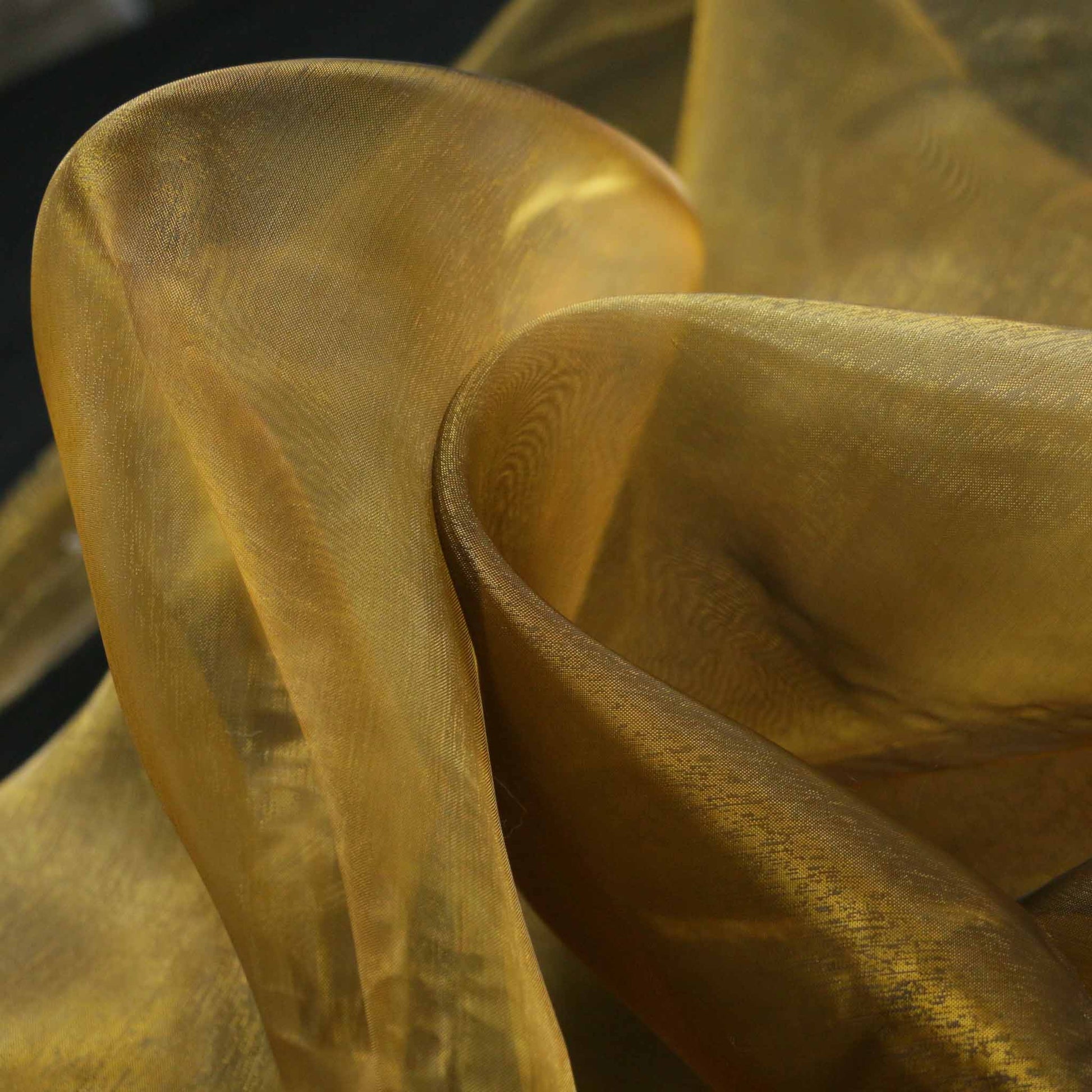 two tone organza dressmaking fabric in black and gold