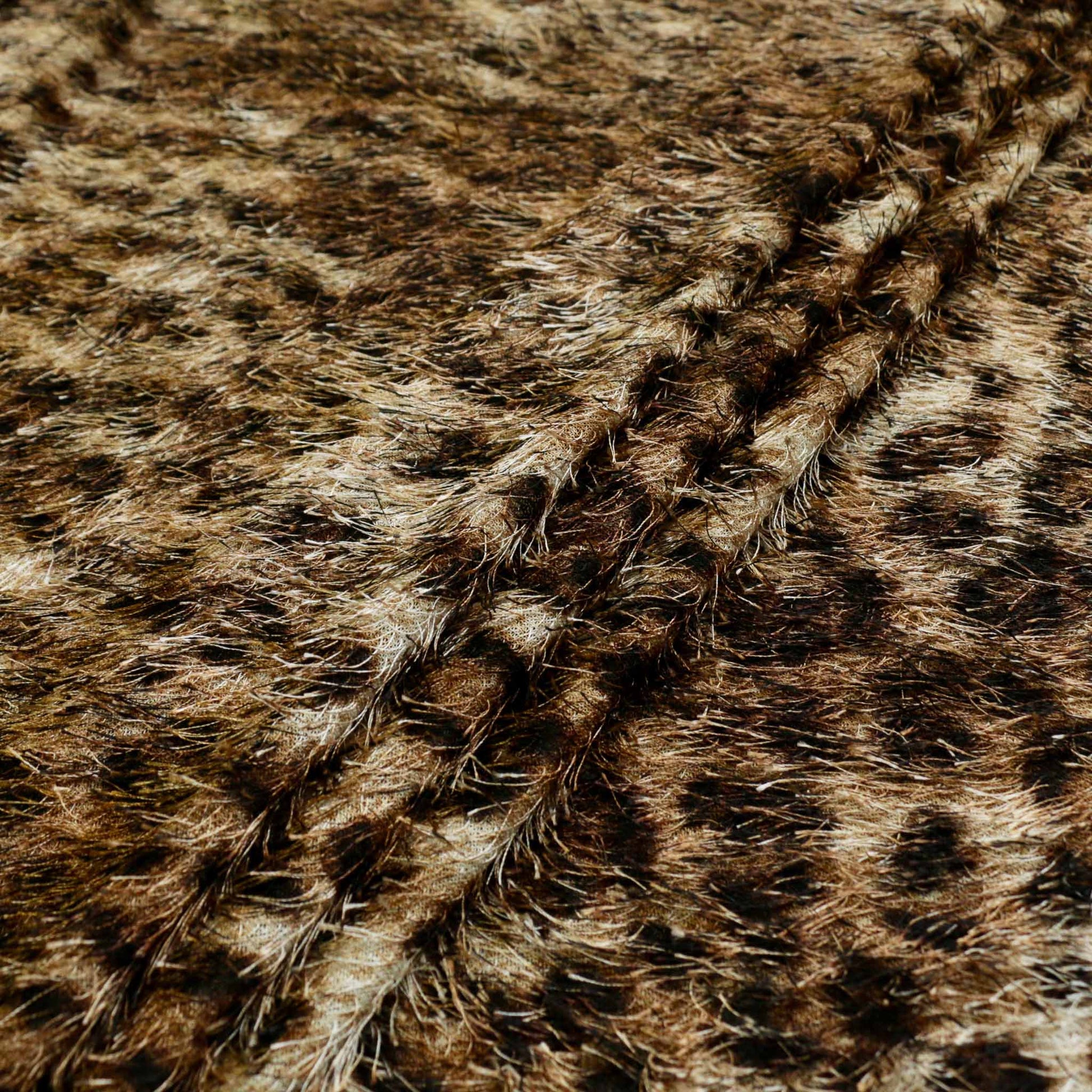 folded eyelash jaguar animal print dressmaking fabric in golden brown