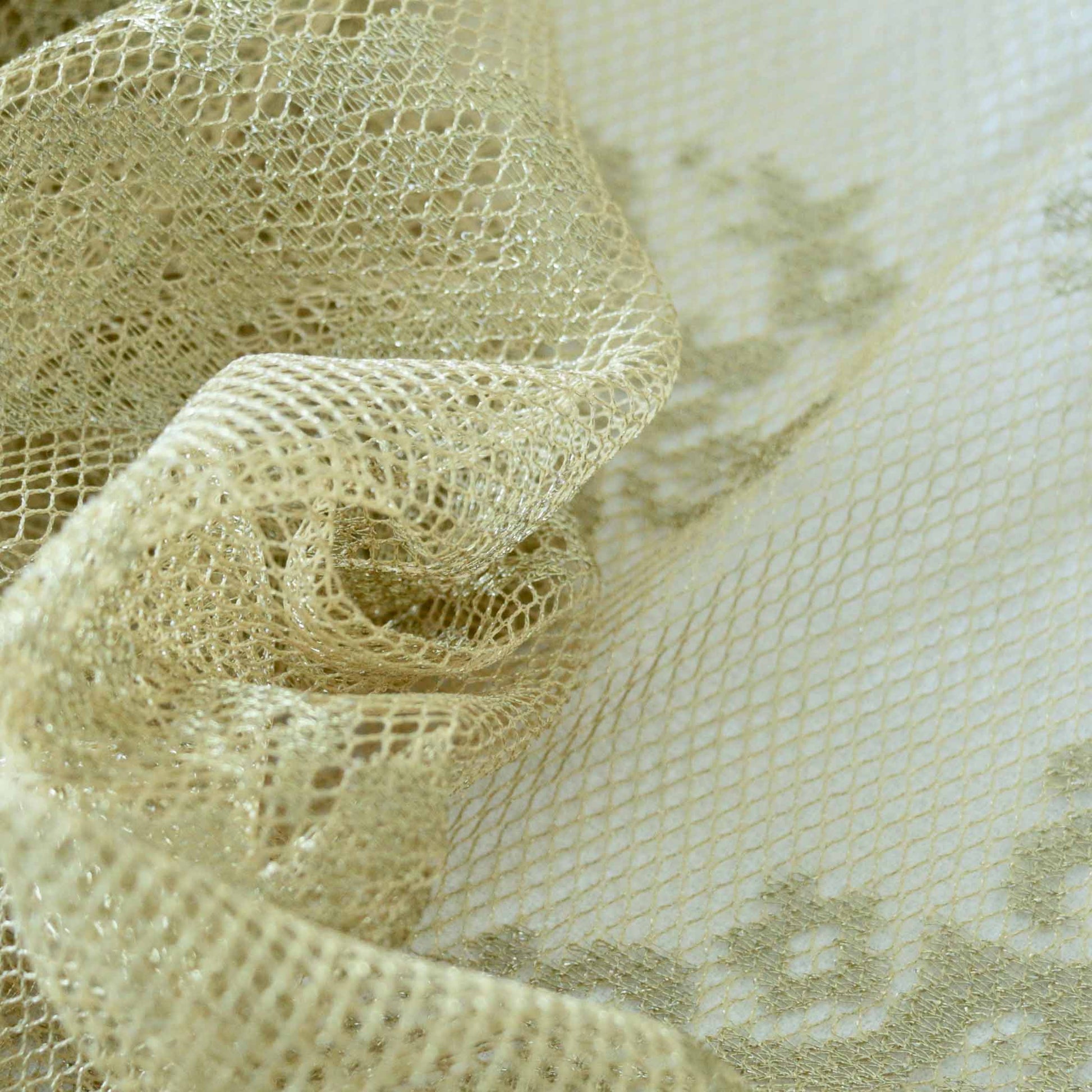 lace dressmaking fabric in gold with delicate rose design