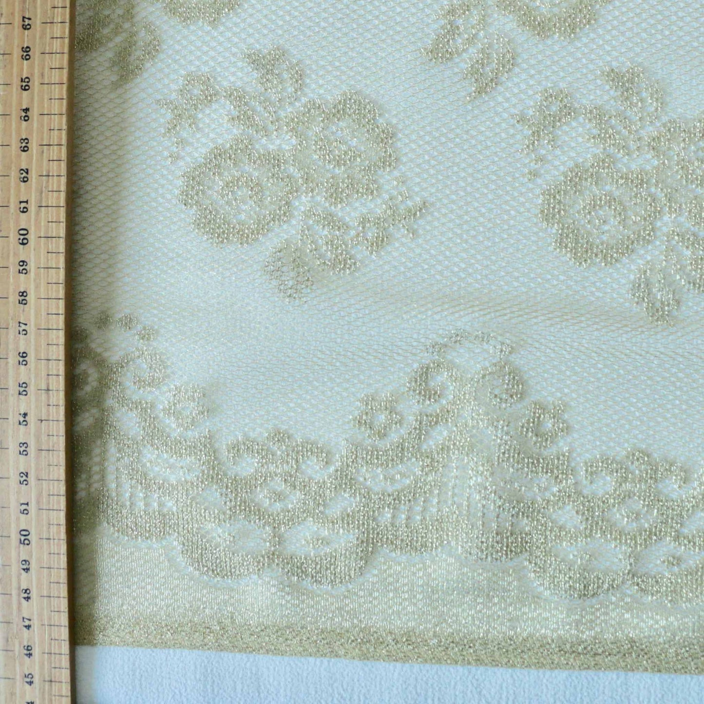 gold lace dressmaking fabric with delicate floral rose design