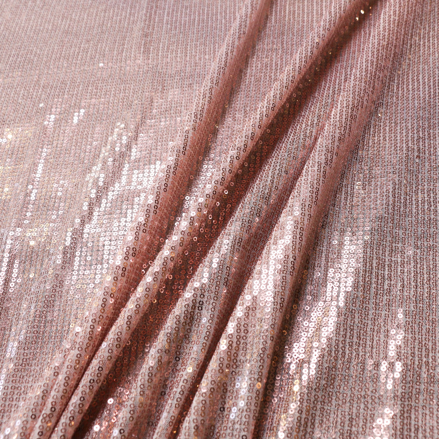 plain sequin dressmaking fabric in rose gold