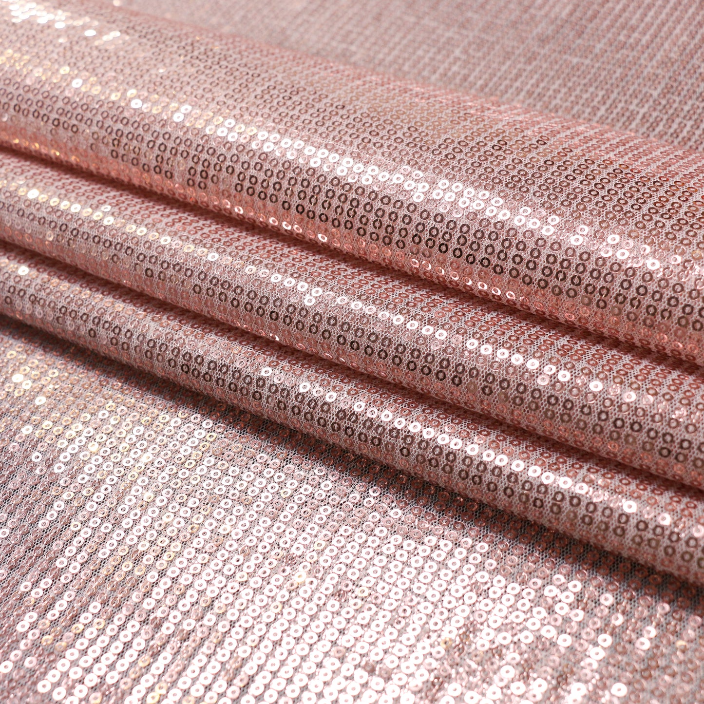 rose gold sequins on white mesh dressmaking fabric