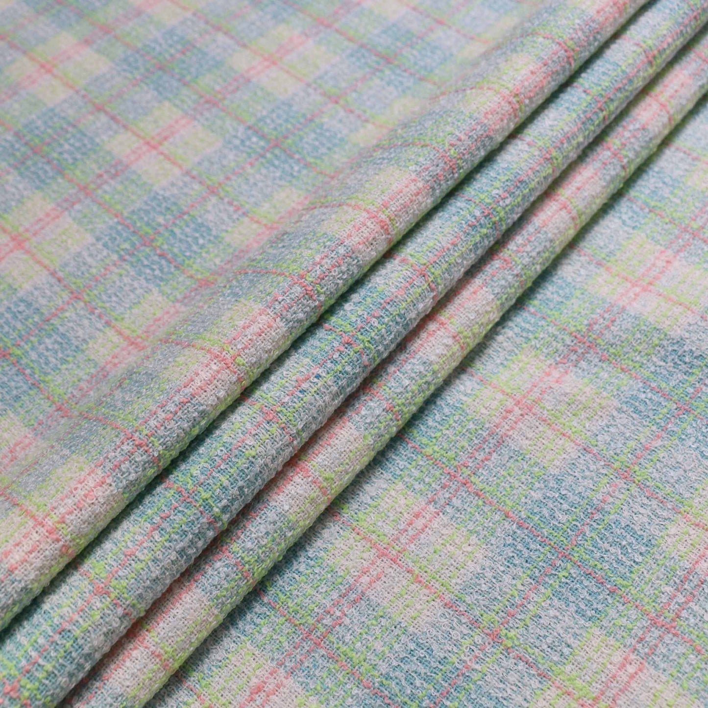 mint green wool blend boucle dressmaking fabric with check pattern