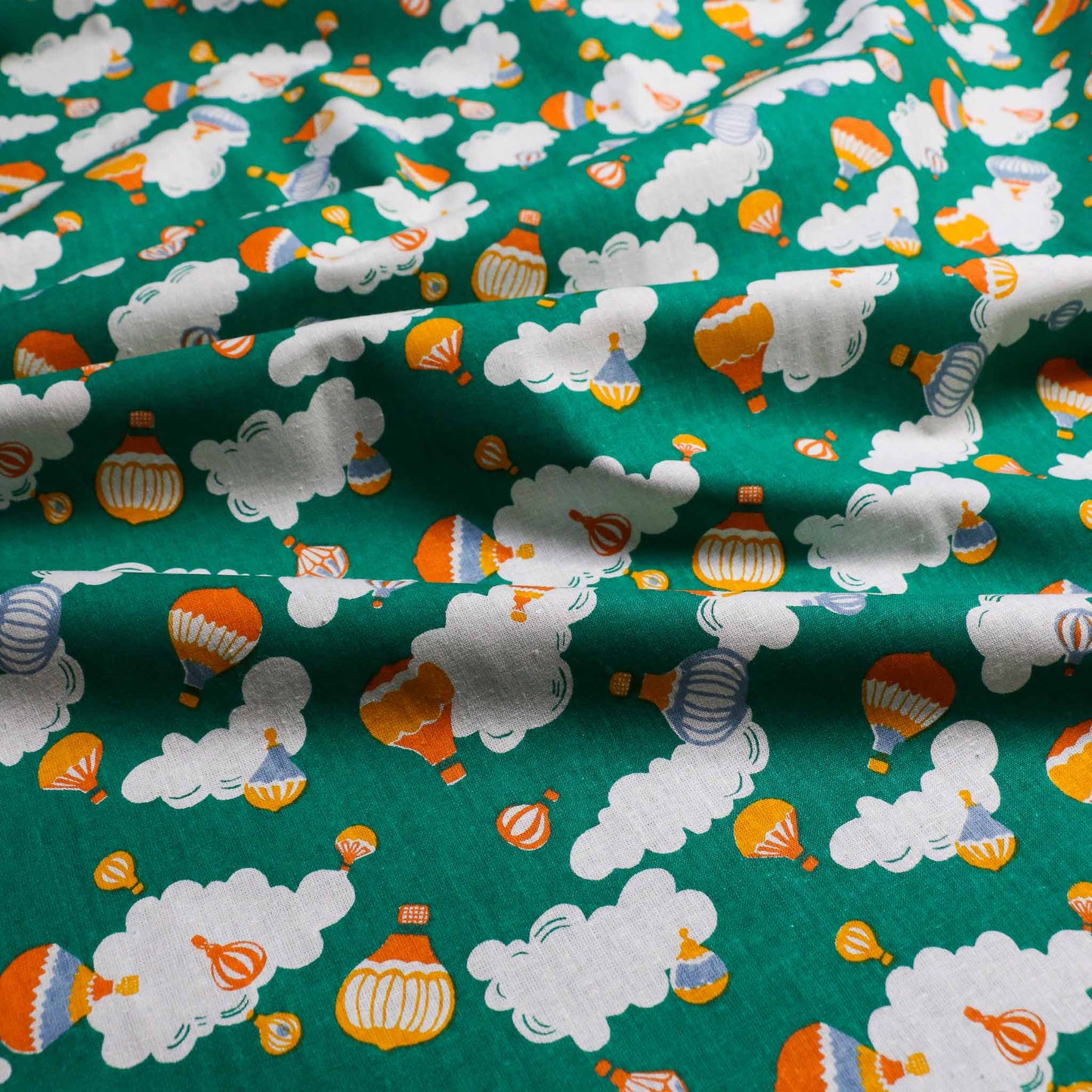 green retro sustainable cotton with hot air balloon clouds print for retro eco dressmaking