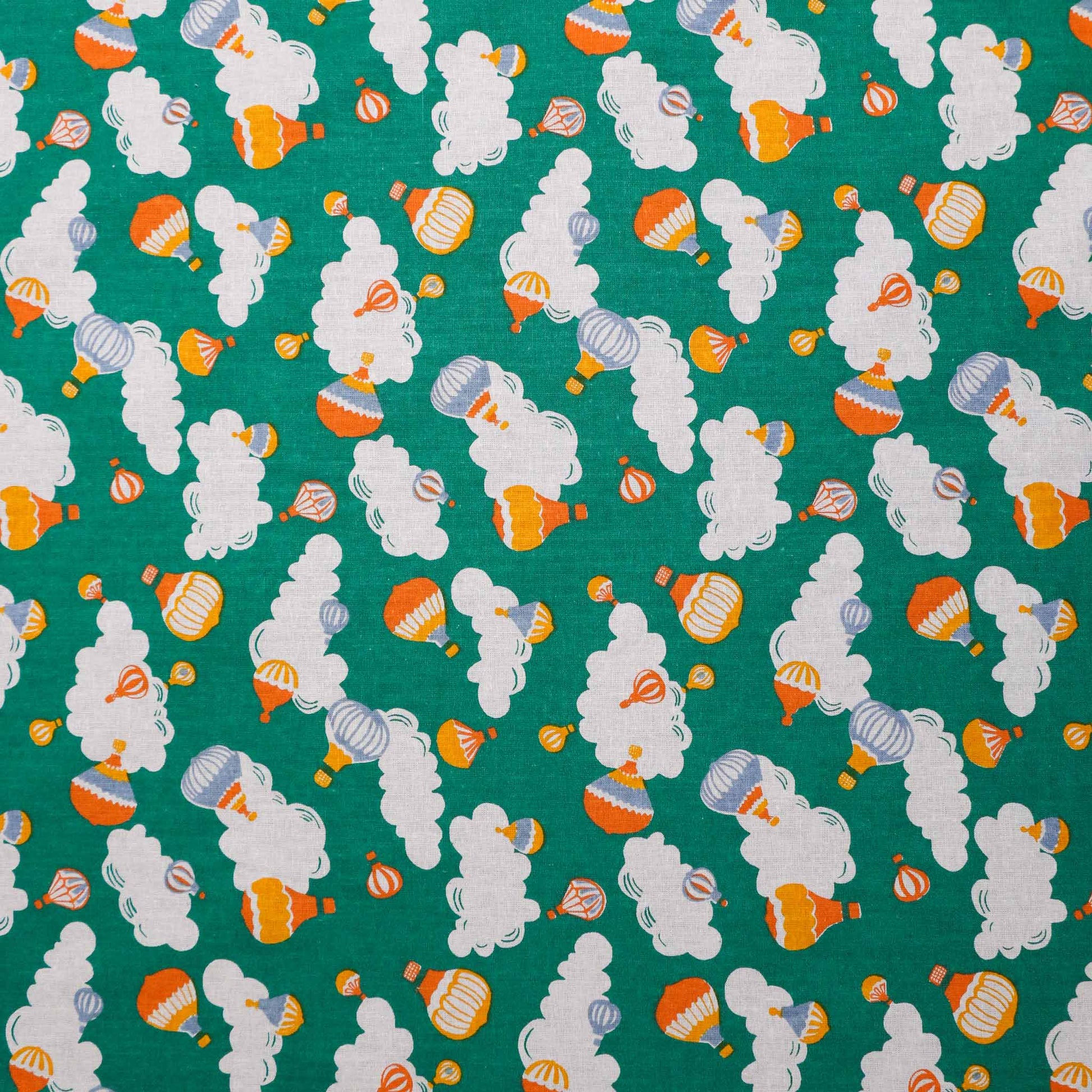 green retro sustainable cotton poplin dress fabric with printed hot air balloon clouds pattern