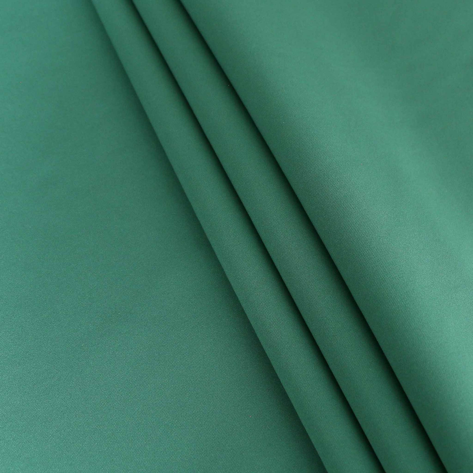 folded green scuba jersey fabric for dressmaking