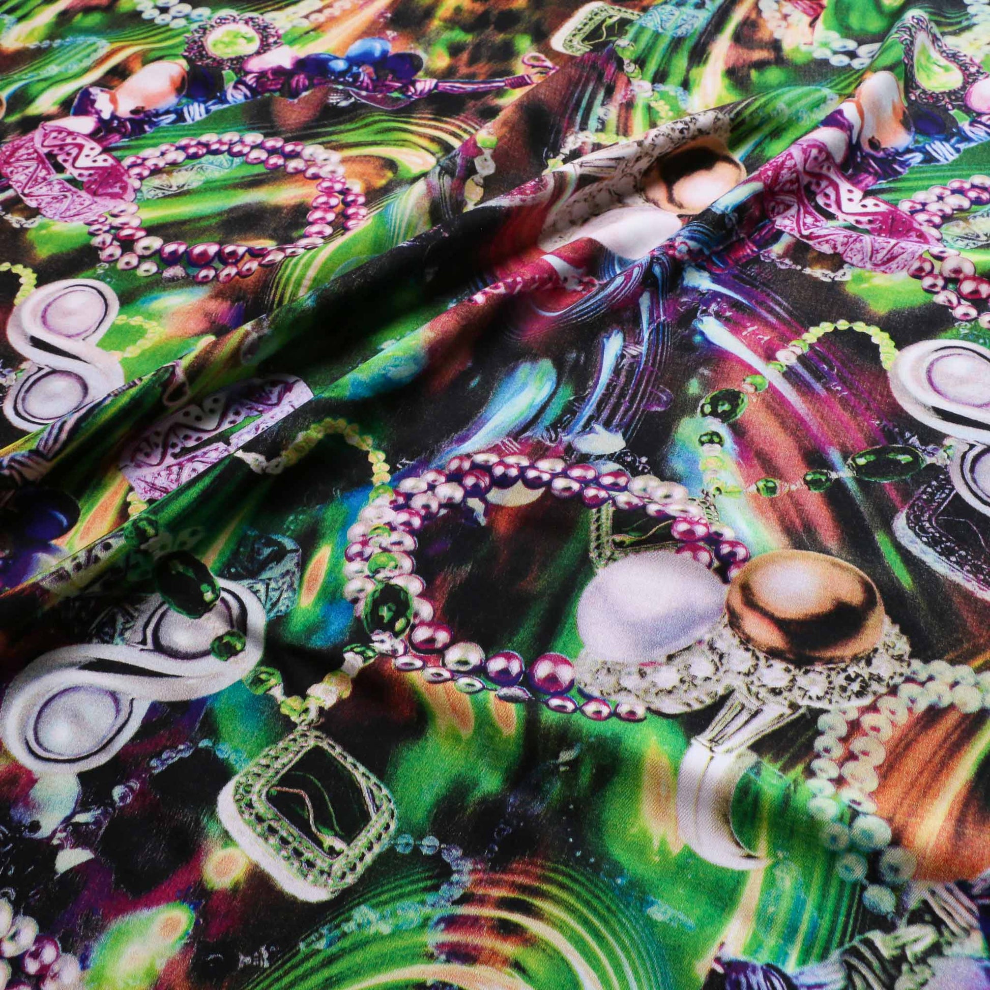 green viscose challis dressmaking fabric with purple and blue jewellery designed print
