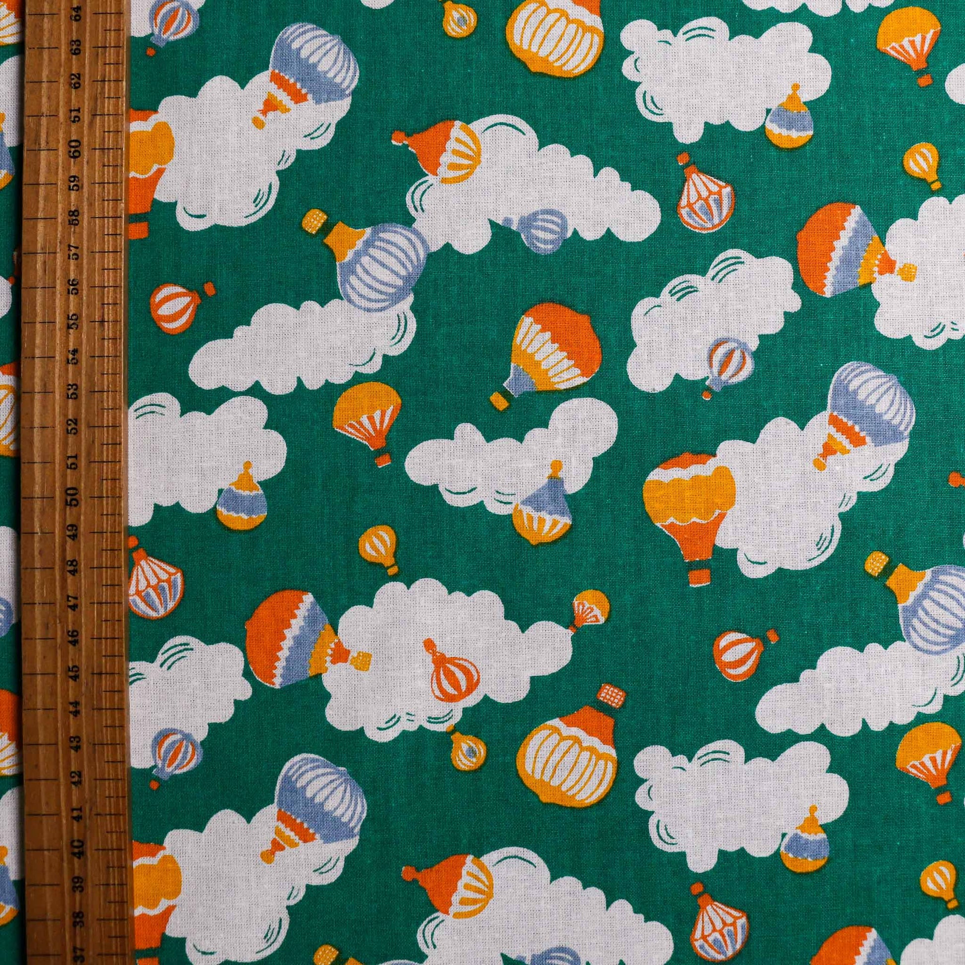 green hot air balloon clouds printed retro cotton poplin dressmaking fabric for sustainable clothes