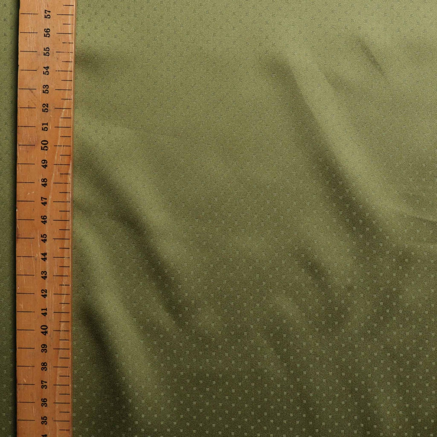 metre green shiny lining dressmaking fabric with jacquard dots design