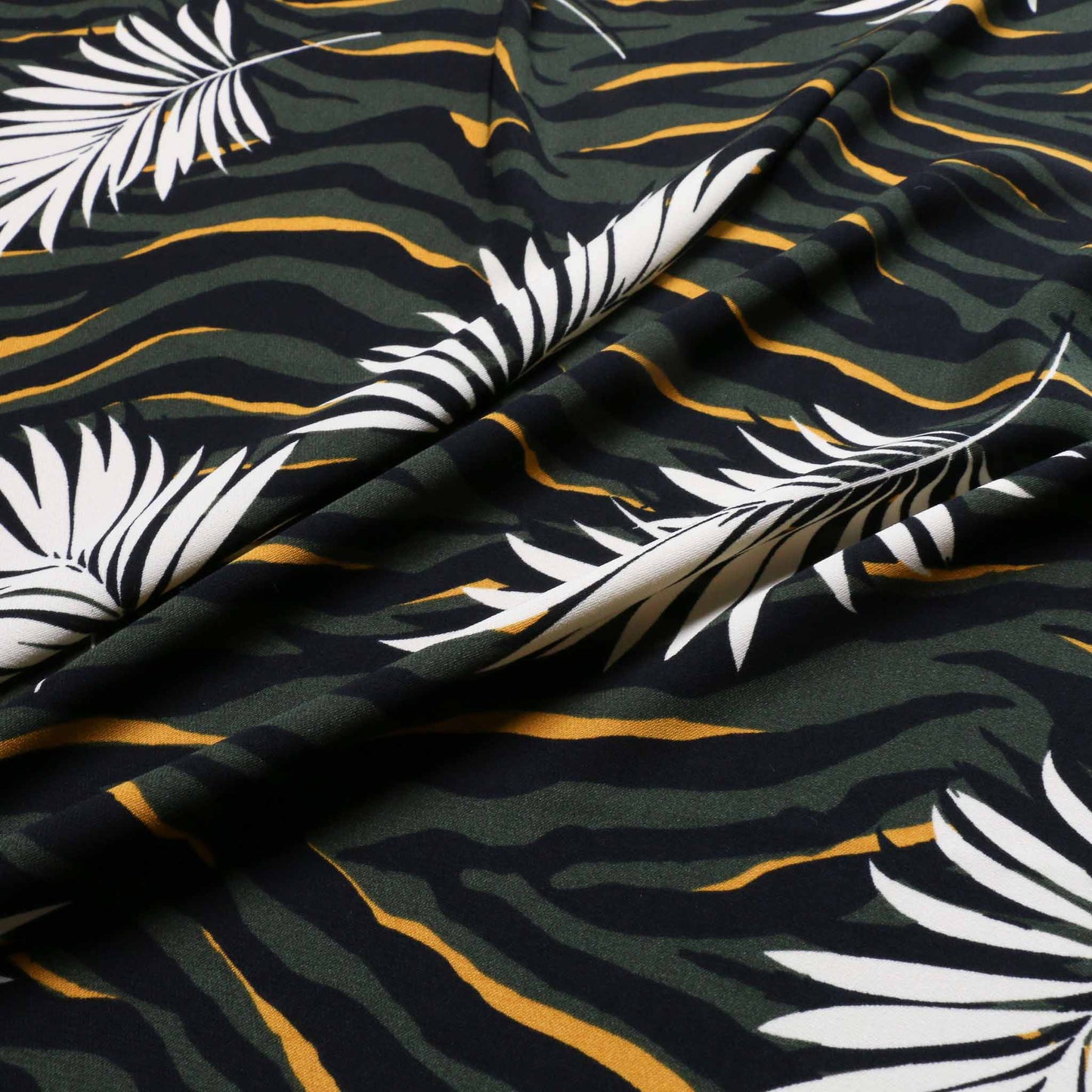 khaki and yellow challis dressmaking fabric with tropical leaf and zebra print