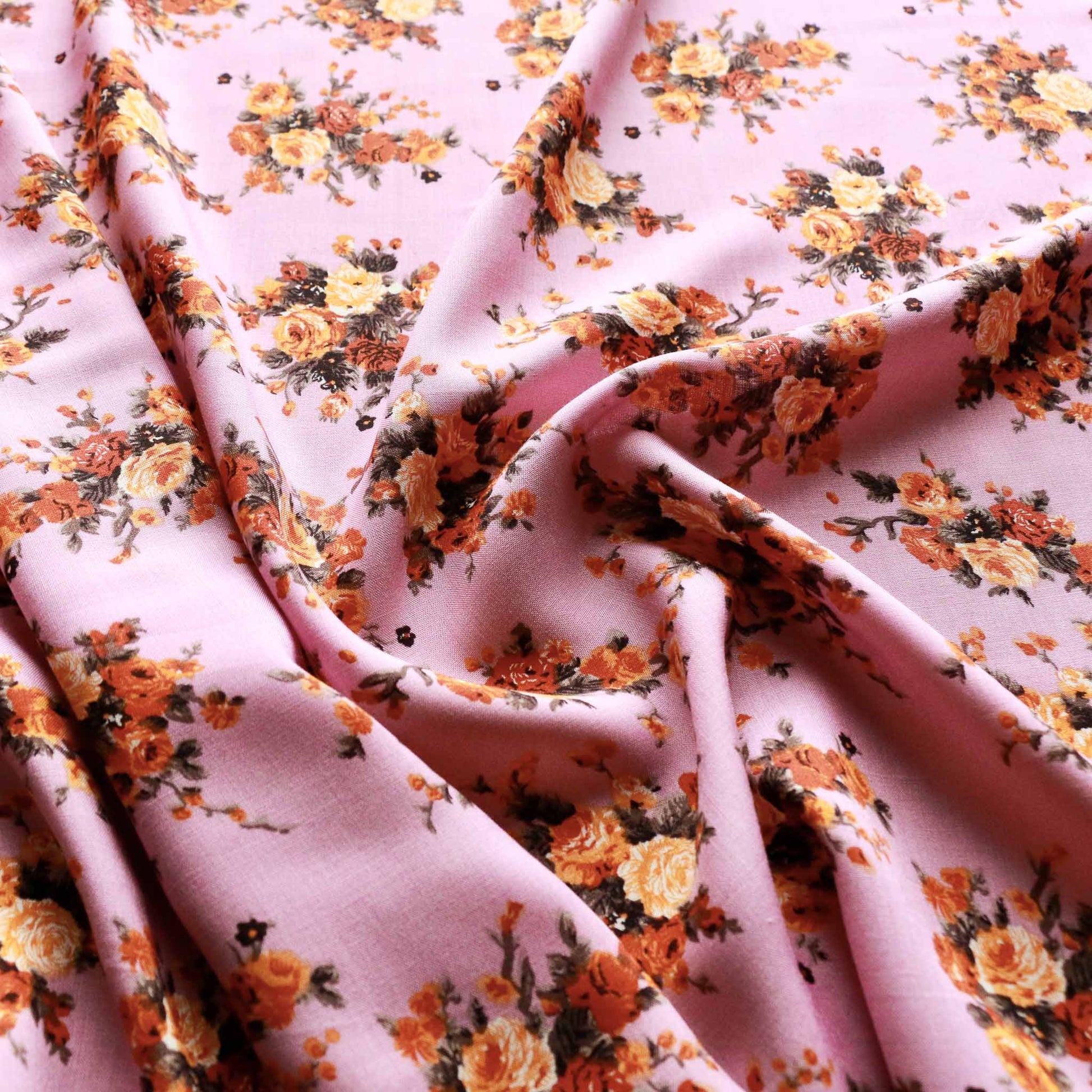 viscose challis dressmaking rayon fabric in lilac with floral printed flowers in orange and yellow