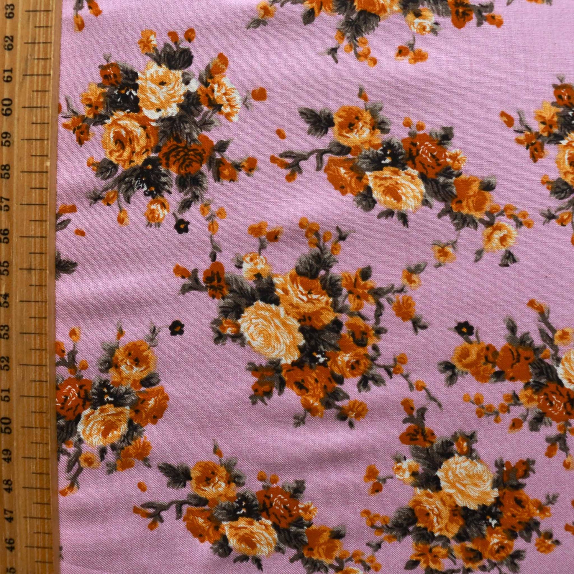 metre lilac viscose challis dressmaking fabric with classic floral print in orange yellow and green