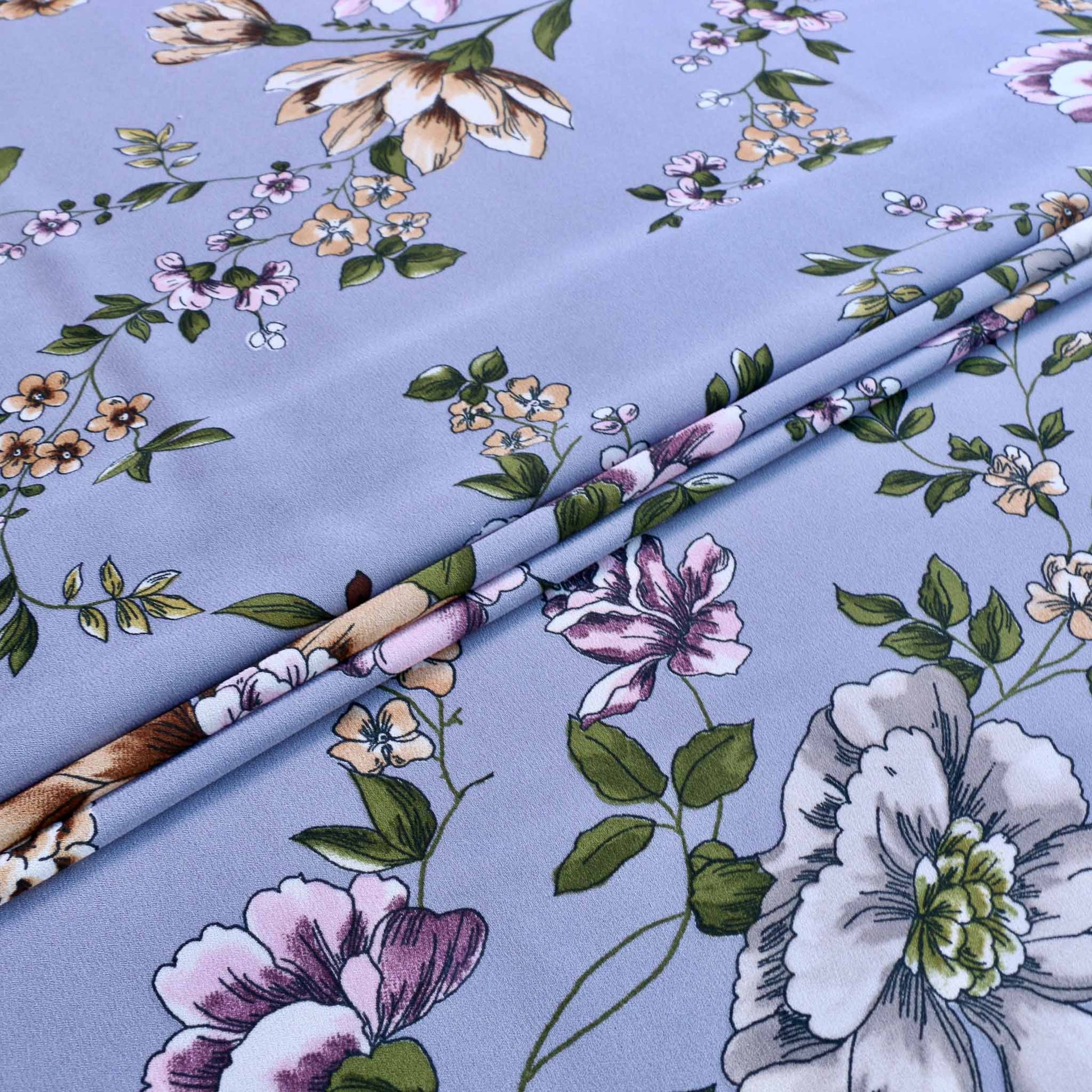 pastel flowers printed on lilac georgette dressmaking fabric