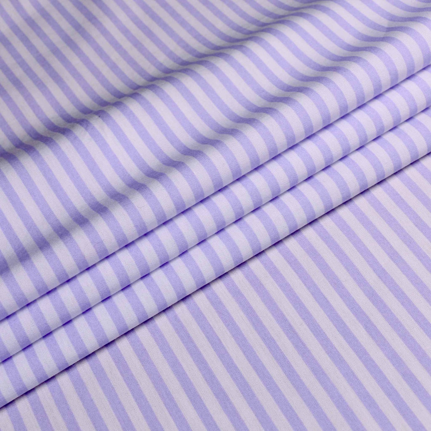 cotton poplin dressmaking fabric with lilac stripe folded