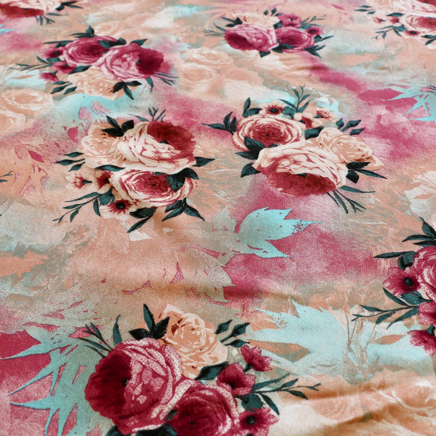 pastel coloured beige and pink viscose challis dressmaking rayon fabric with large floral design