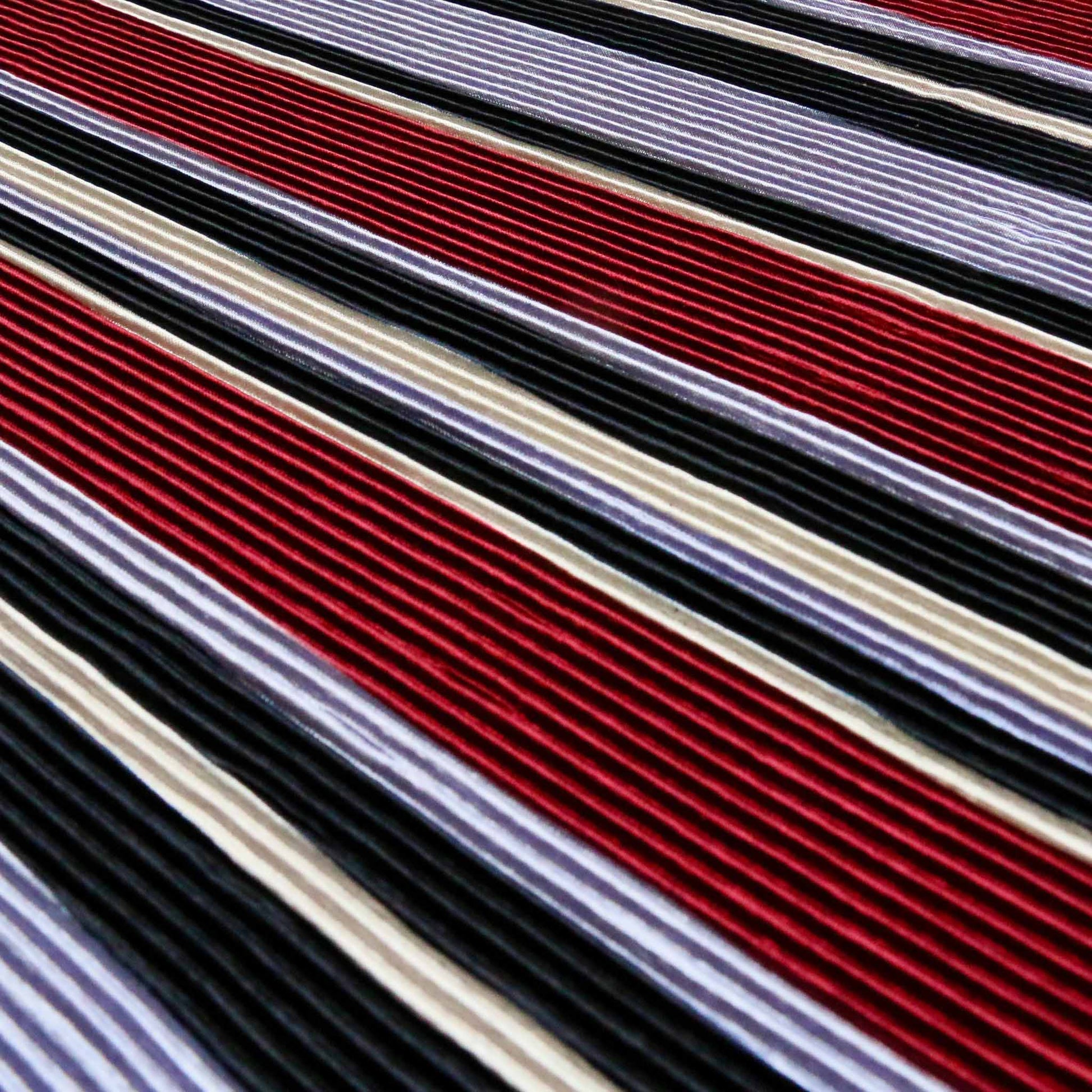 stripey plisse dressmaking fabric with pleated texture and blue and maroon striped design