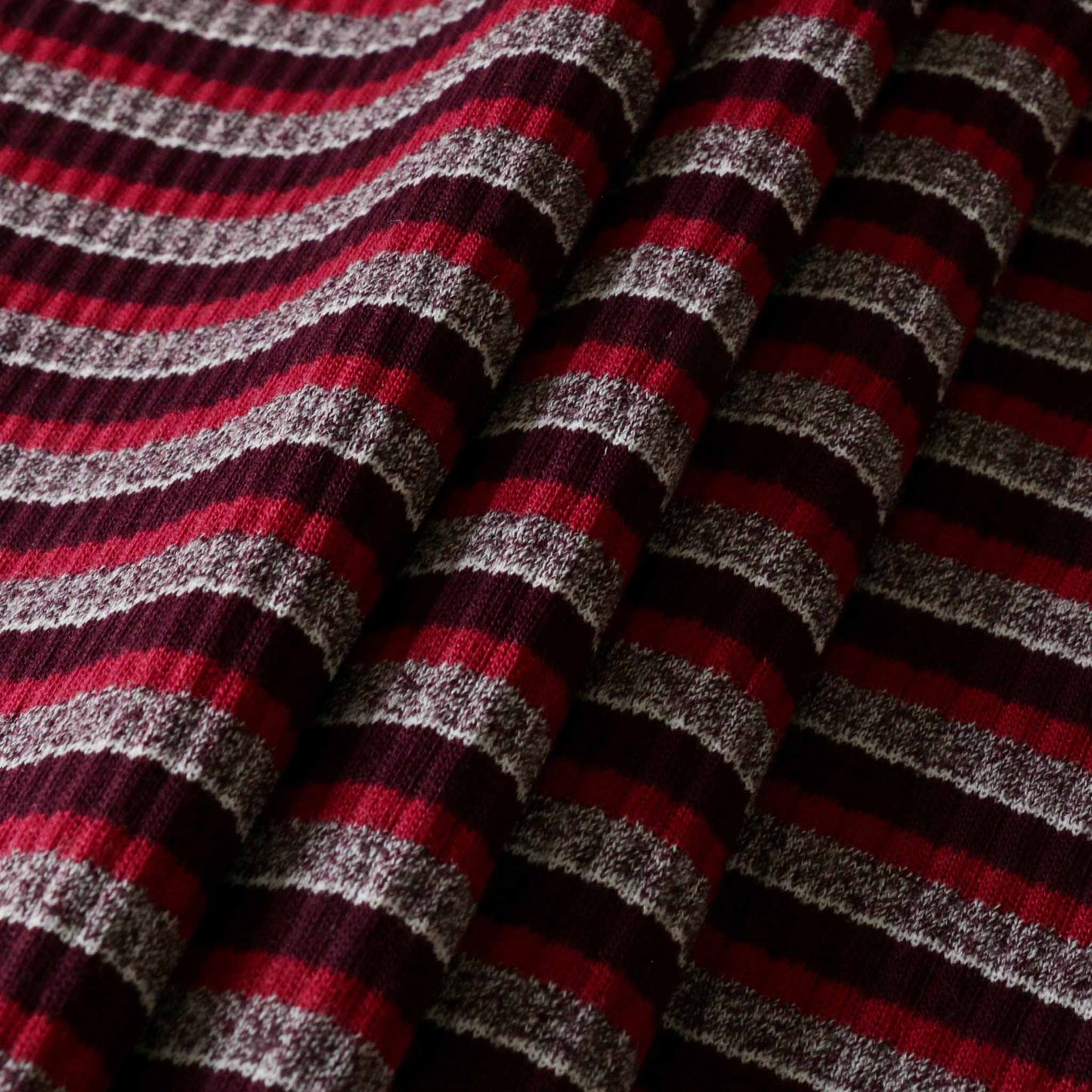 striped rib jersey knit dressmaking fabric with maroon pink and grey stripe design