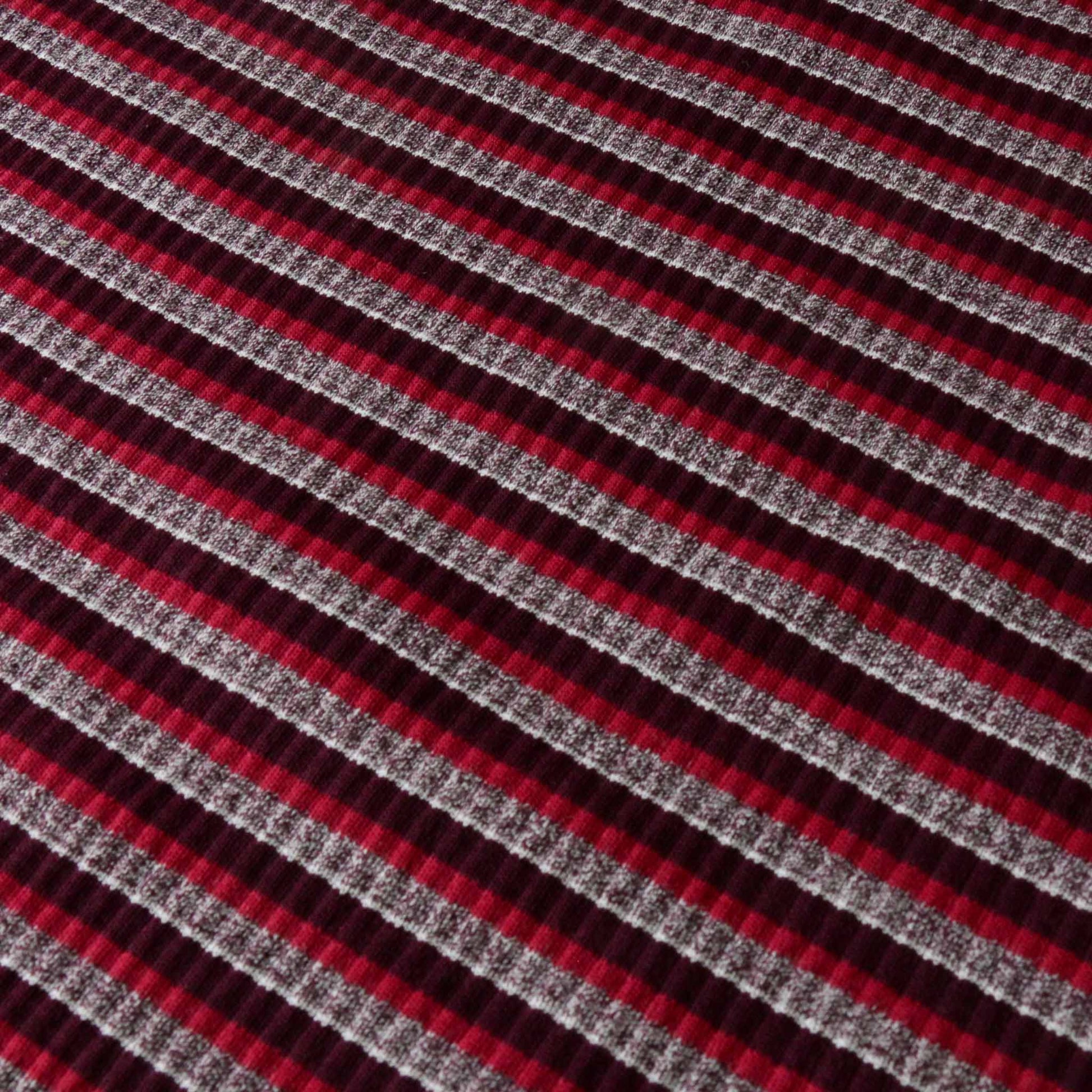 striped rib jersey knit dressmaking fabric with striped design in maroon pink and grey