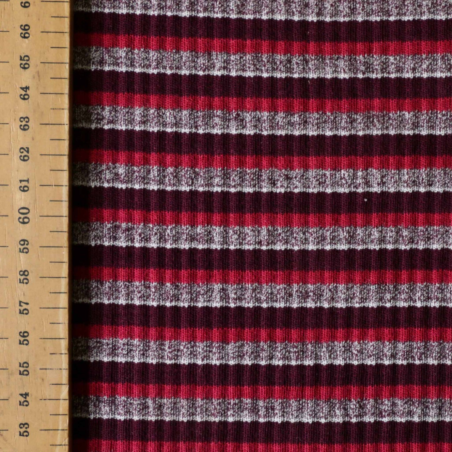 metre rib jersey knit dressmaking fabric with tubular stripe pattern in maroon and pink 